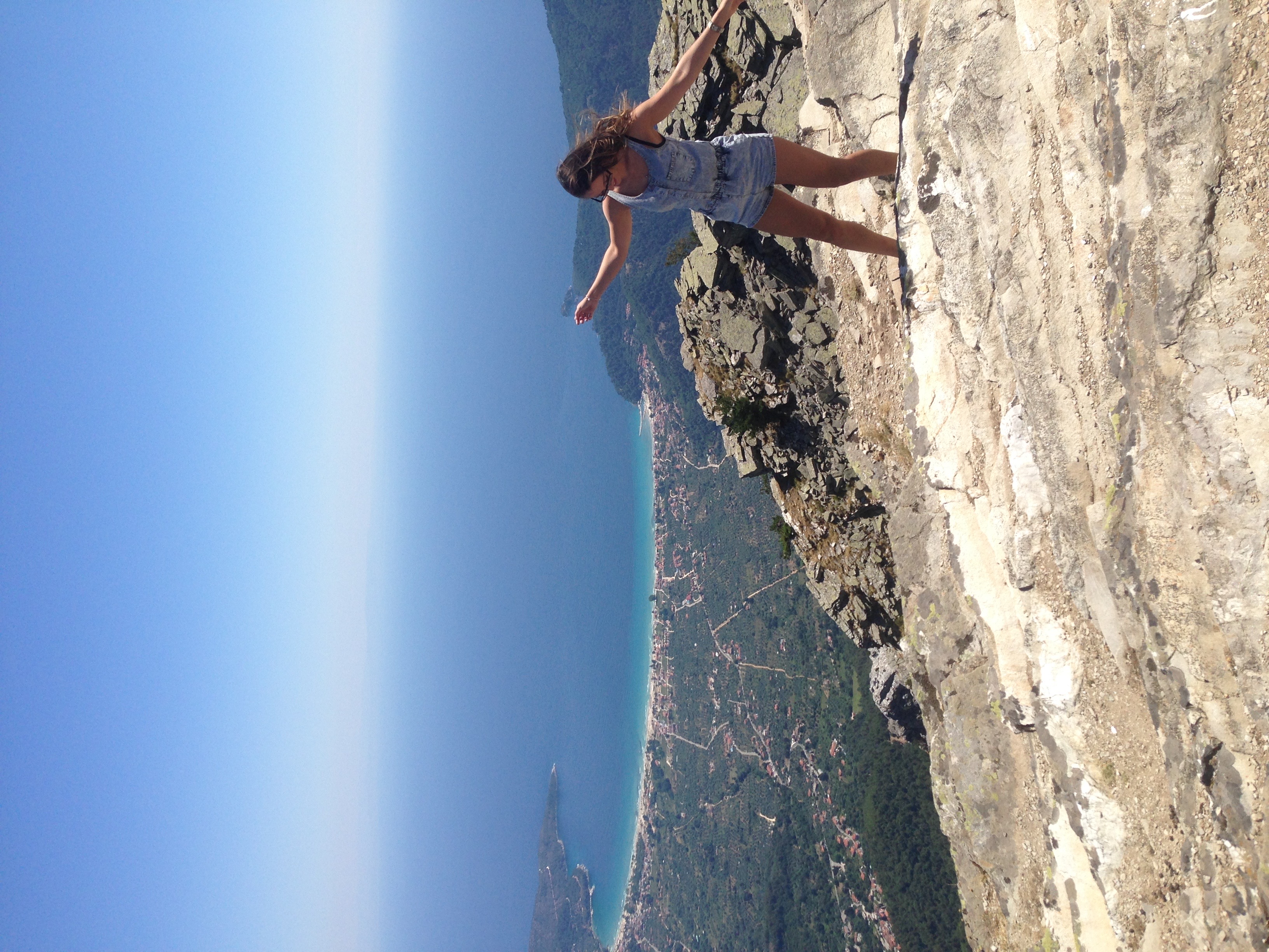 how to travel the world, how to make life changing decisions, area wide open at a tall viewpoint on an island with sea in the background