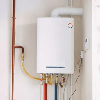 Tankless water heater installed on an interior wall by R&K Plumbing in Pensacola, FL