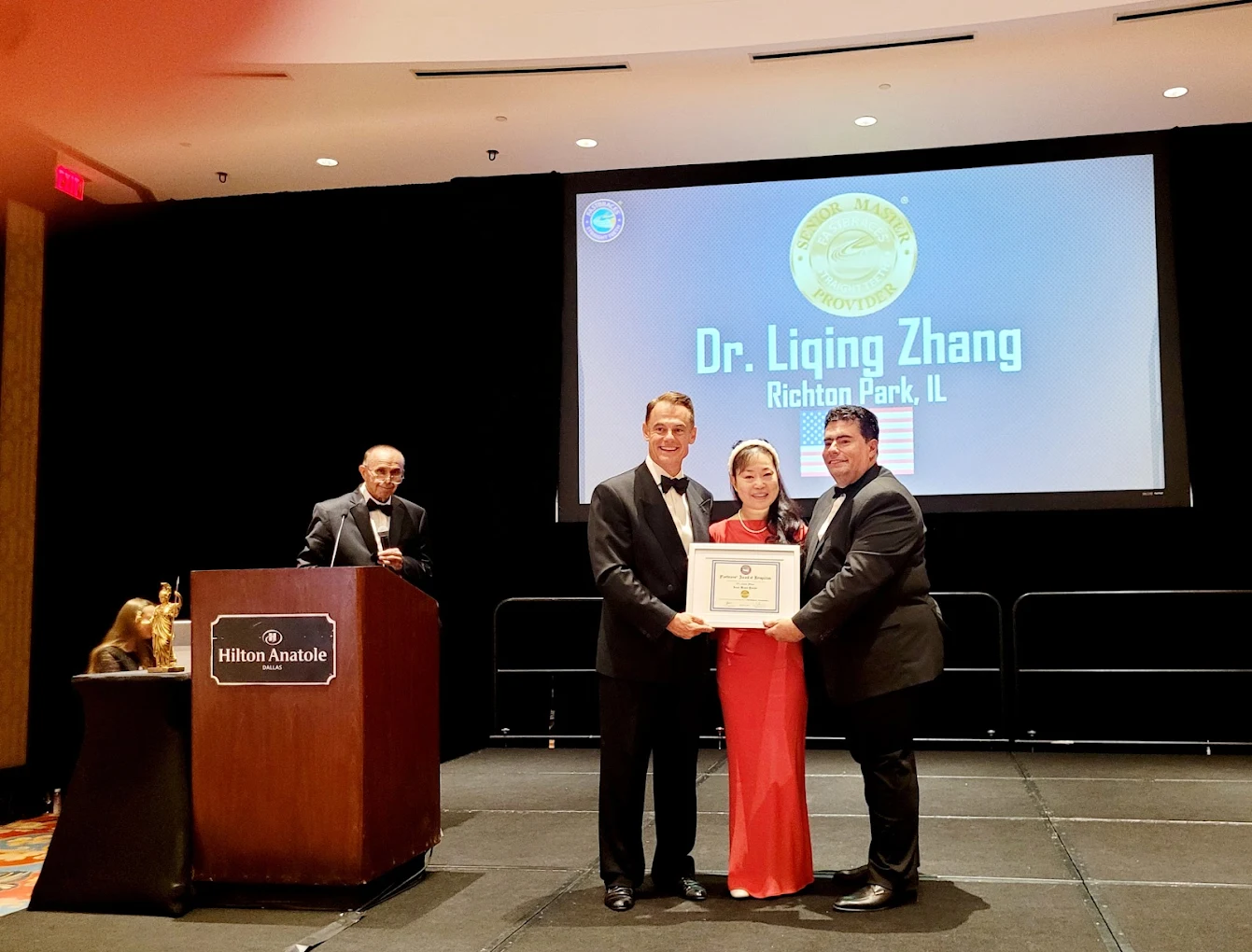 Dr. Liqing Zhang DDS accepting Fastbraces Senior Master Provider award ceremony