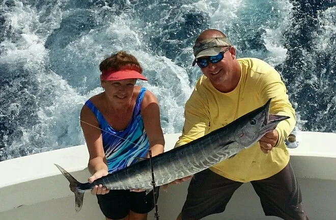 Happy anglers holding a big fish on a RingMaster Charters half-day trip off Pompano Beach, Florida.