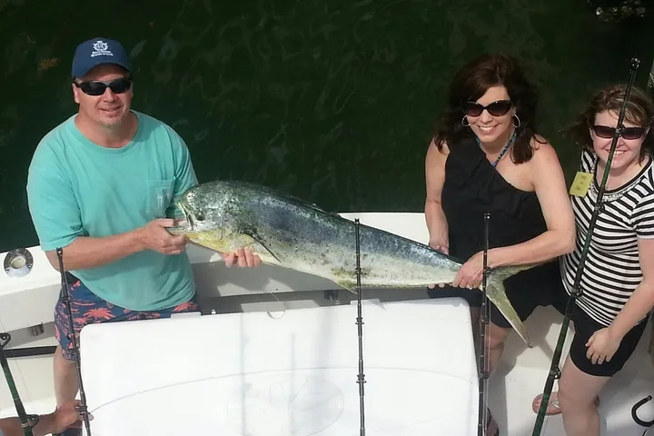Happy anglers holding a big fish on a RingMaster Charters half-day trip off Pompano Beach, Florida.