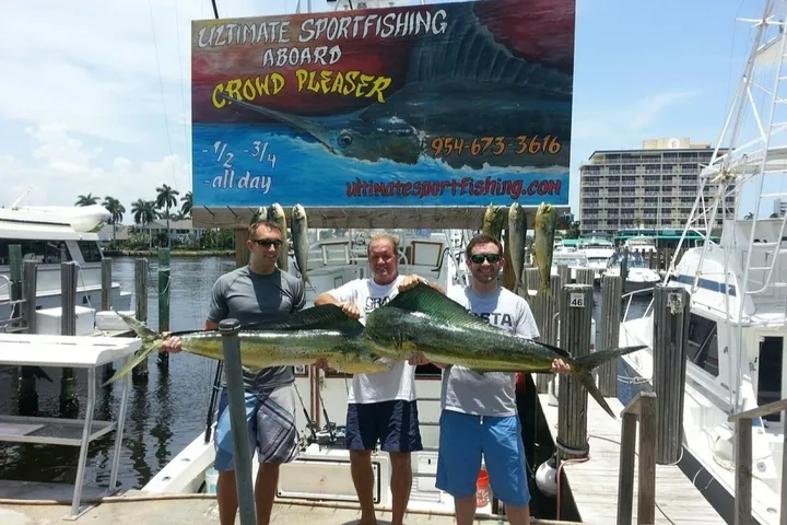 Happy anglers holding a big fish on a RingMaster Charters half-day trip off Pompano Beach, Florida.