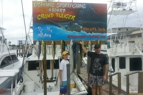 Happy anglers holding a big fish on a RingMaster Charters half-day trip off Pompano Beach, Florida.