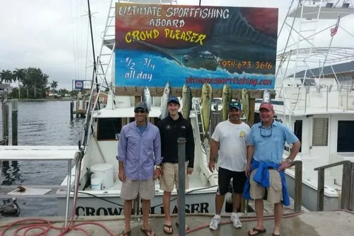 Happy anglers holding a big fish on a RingMaster Charters half-day trip off Pompano Beach, Florida.