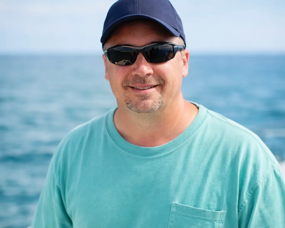 Captain on deck with trolling rods, RingMaster Charters—offshore fishing near Pompano Beach, FL.