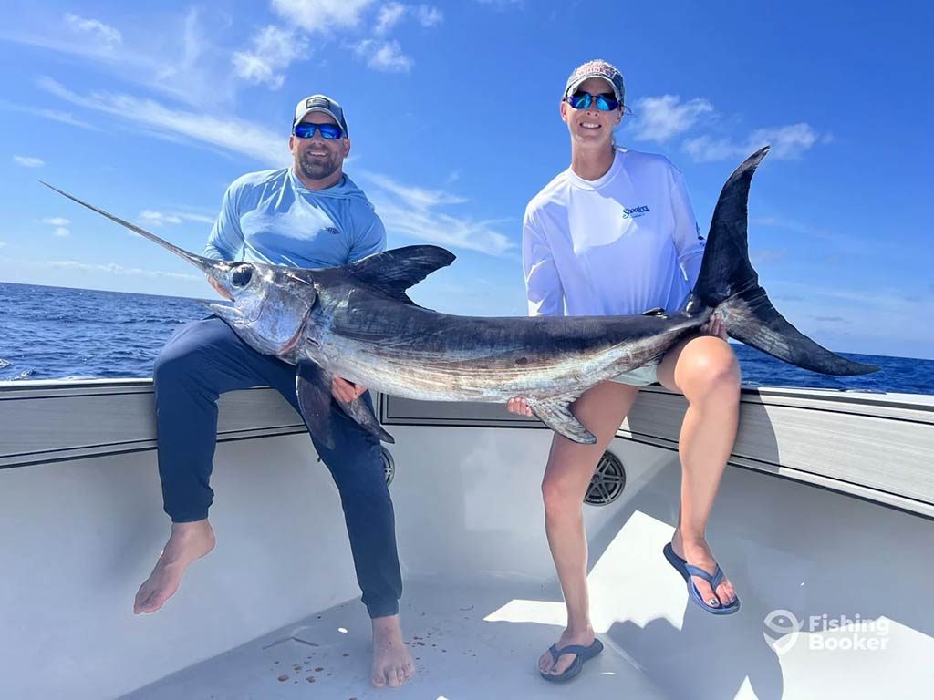 Cockpit POV from RingMaster with trolling spread and bright teal wake during a half-day charter