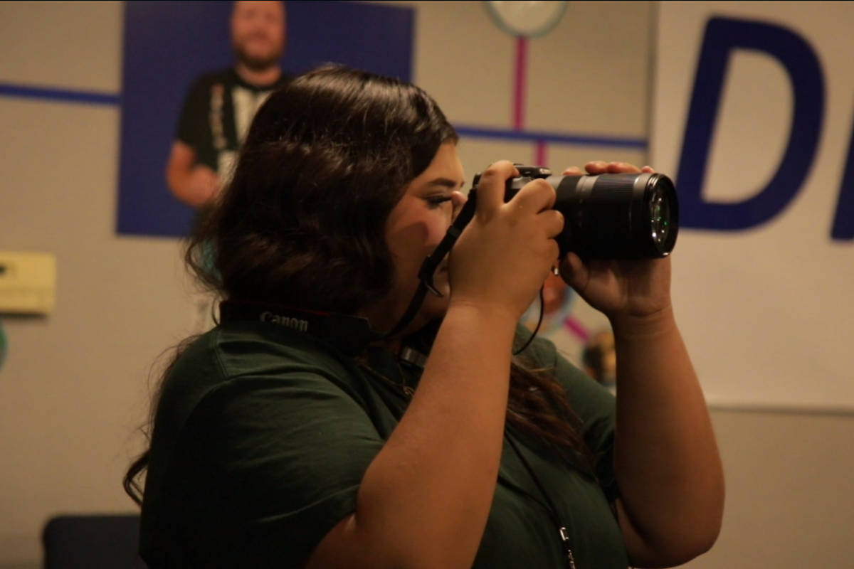 Students working together during a documentary filmmaking session using professional cameras and audio equipment in a hands-on media production environment.