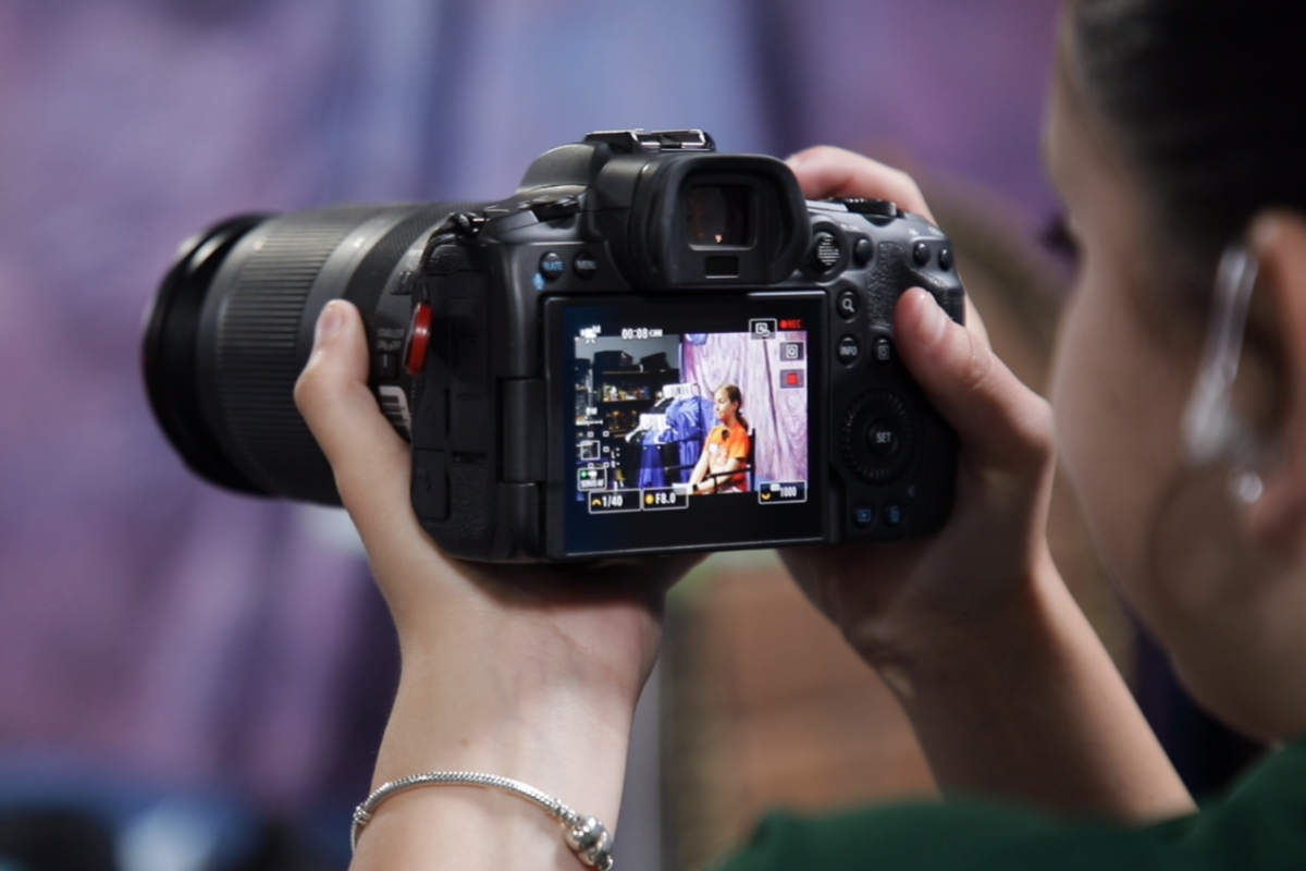 Students working together during a documentary filmmaking session using professional cameras and audio equipment in a hands-on media production environment.