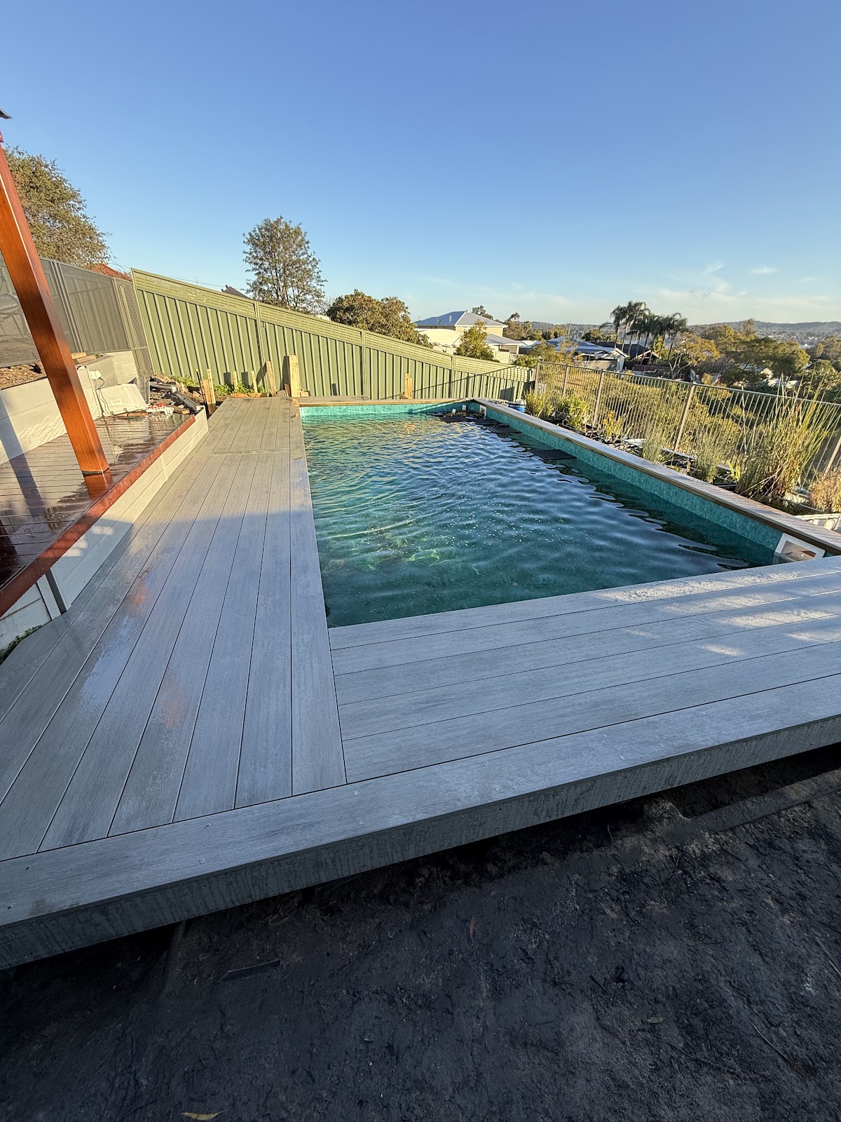 Completed grey composite pool deck by LMCarpentry