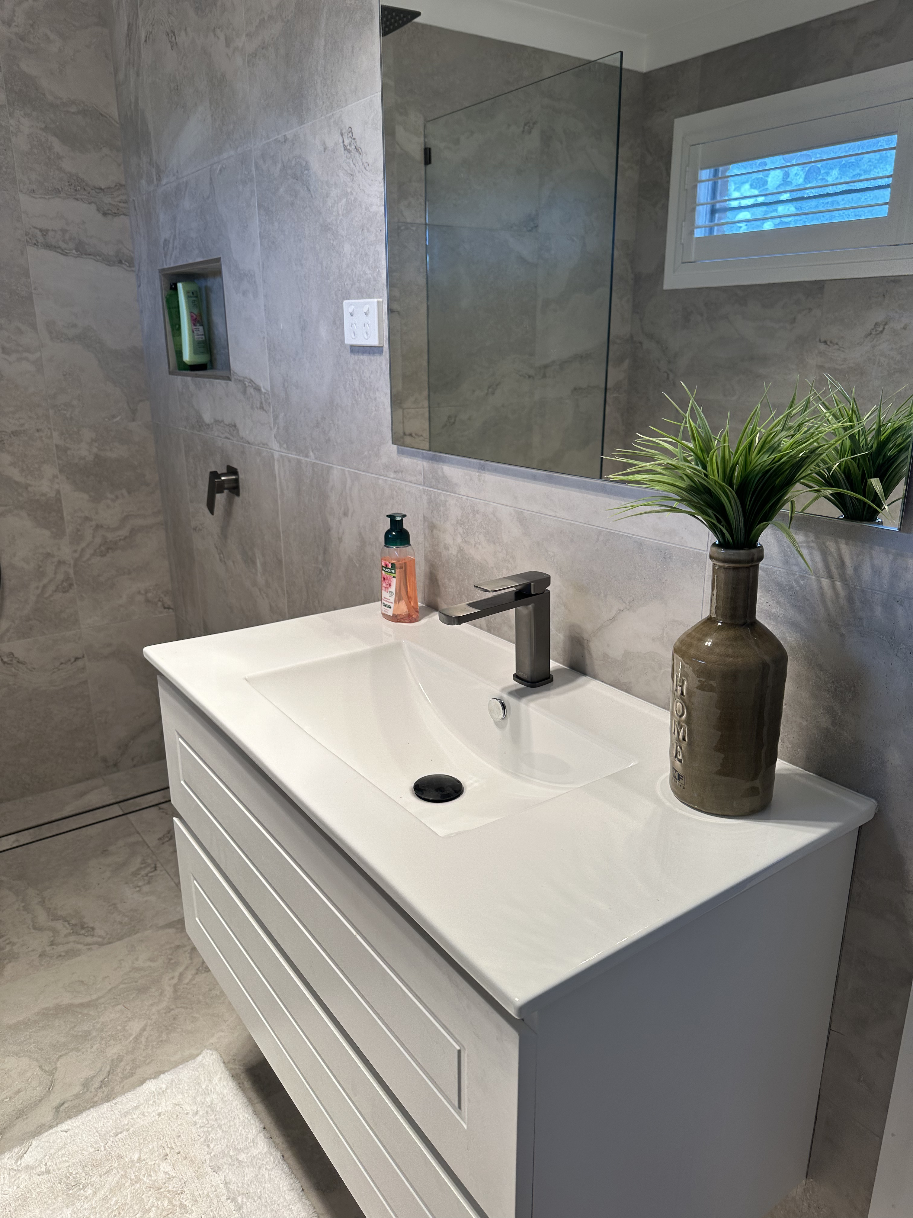 Black rainfall shower head over the corner spa bath in Trangie