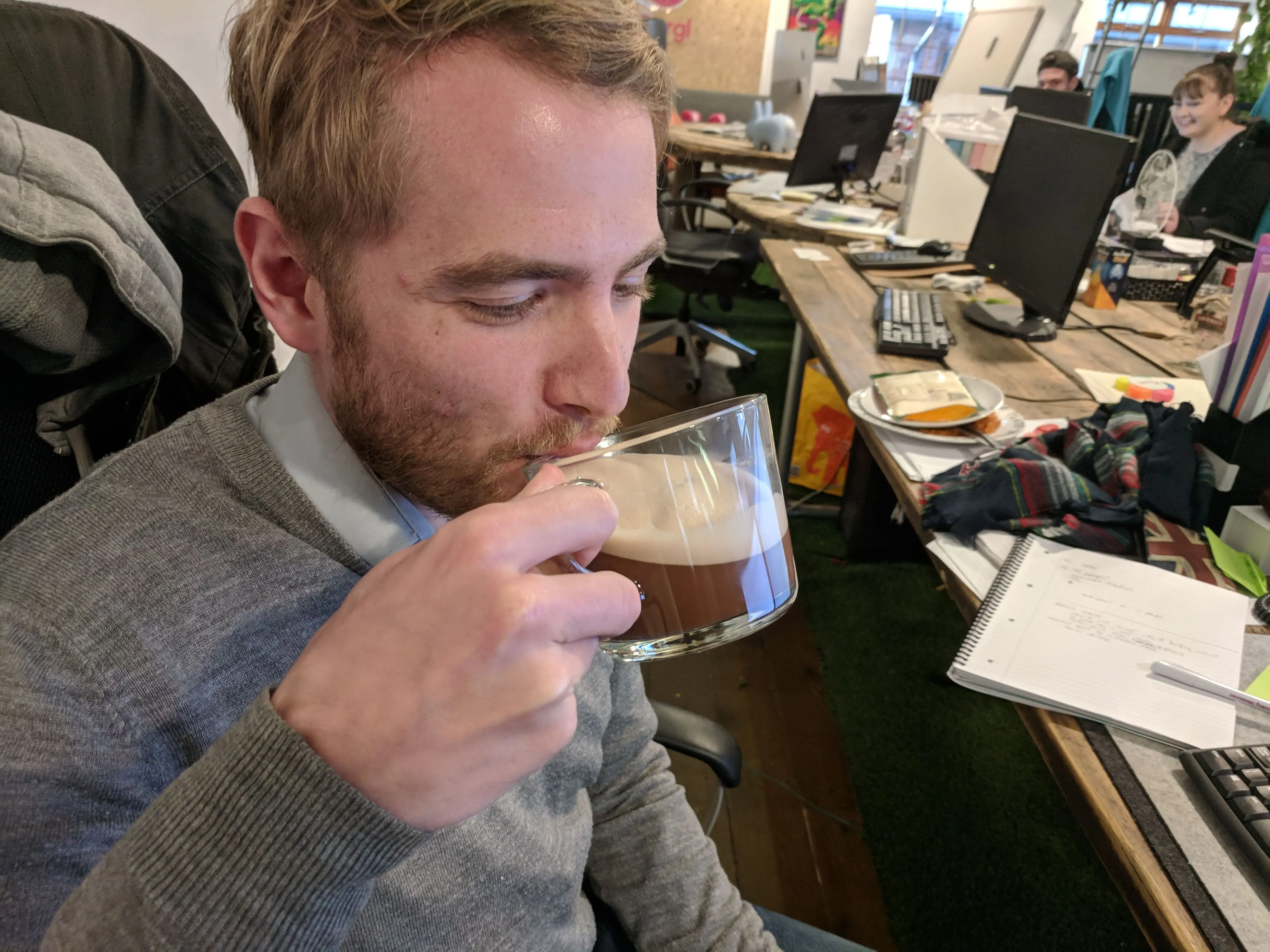 Person calmly making coffee in office