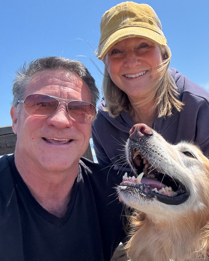 Barry Penner with his wife and golden retriever at the beach