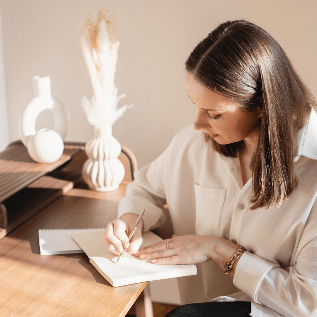 Caucasian woman writing on a notebook