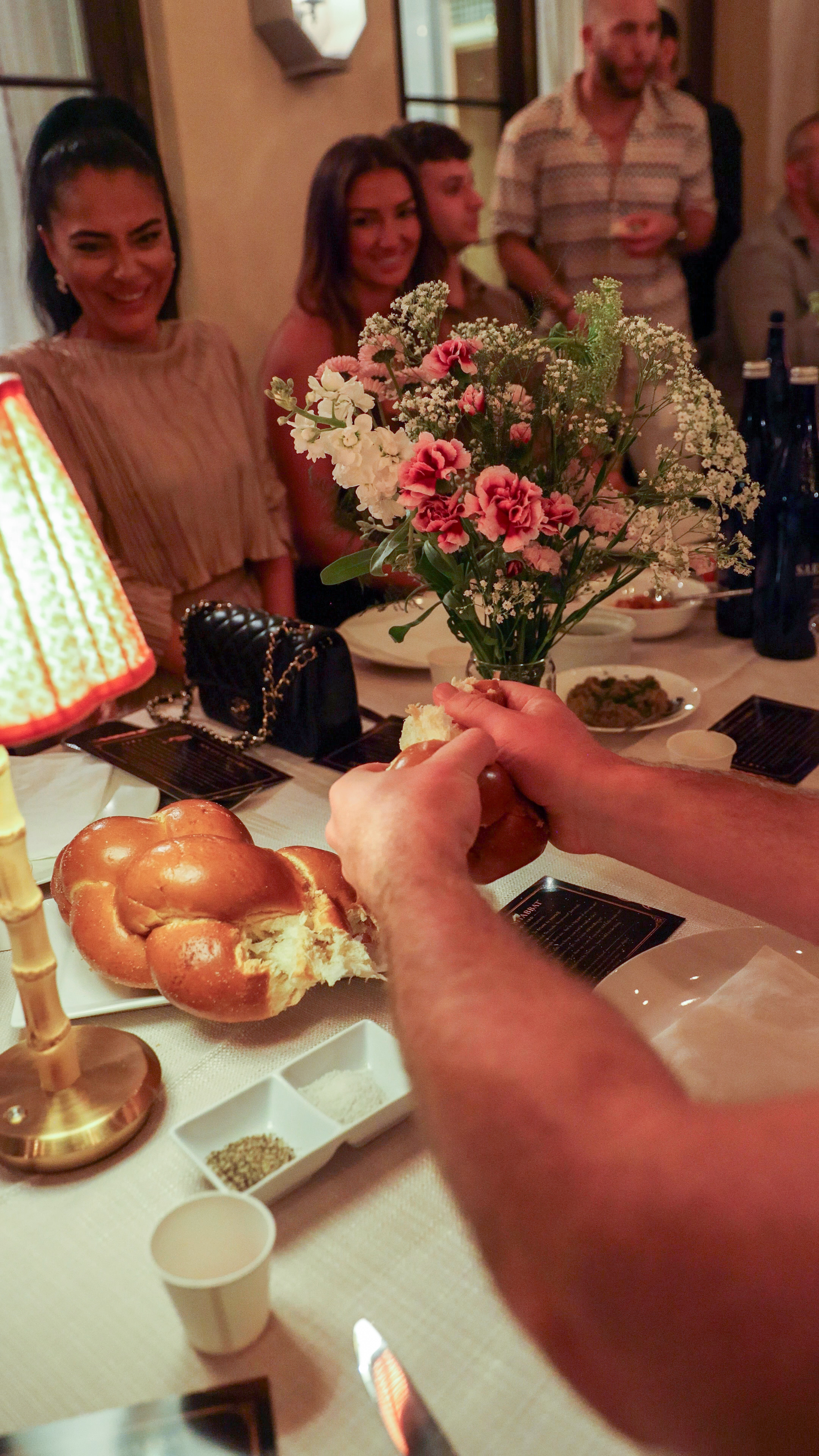 Breaking challah at Soulful Shabbat