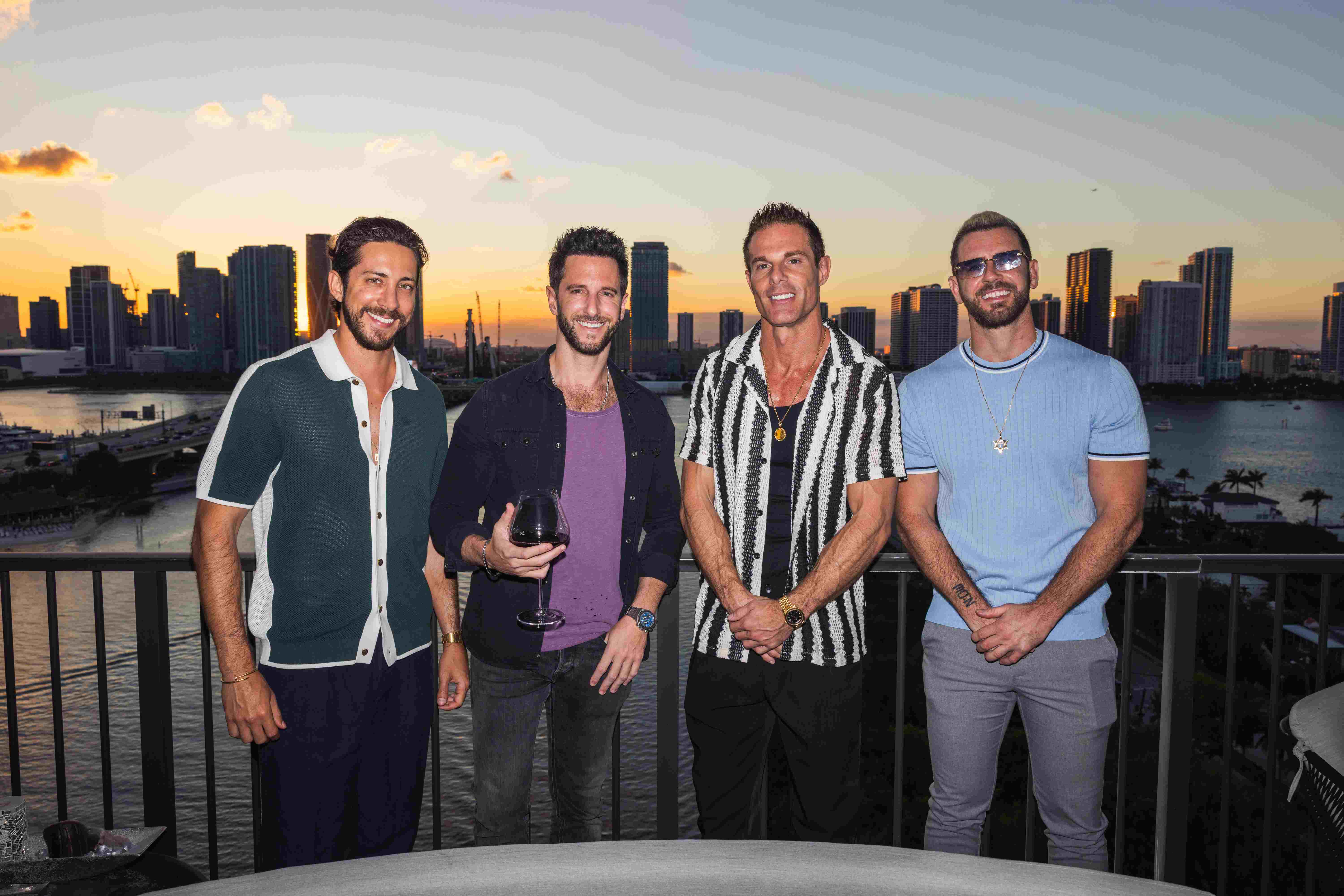 Friends on the rooftop with the Miami skyline
