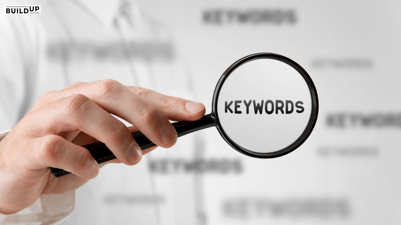 Magnifying glass highlighting the keywords for a competitive keyword gap analysis