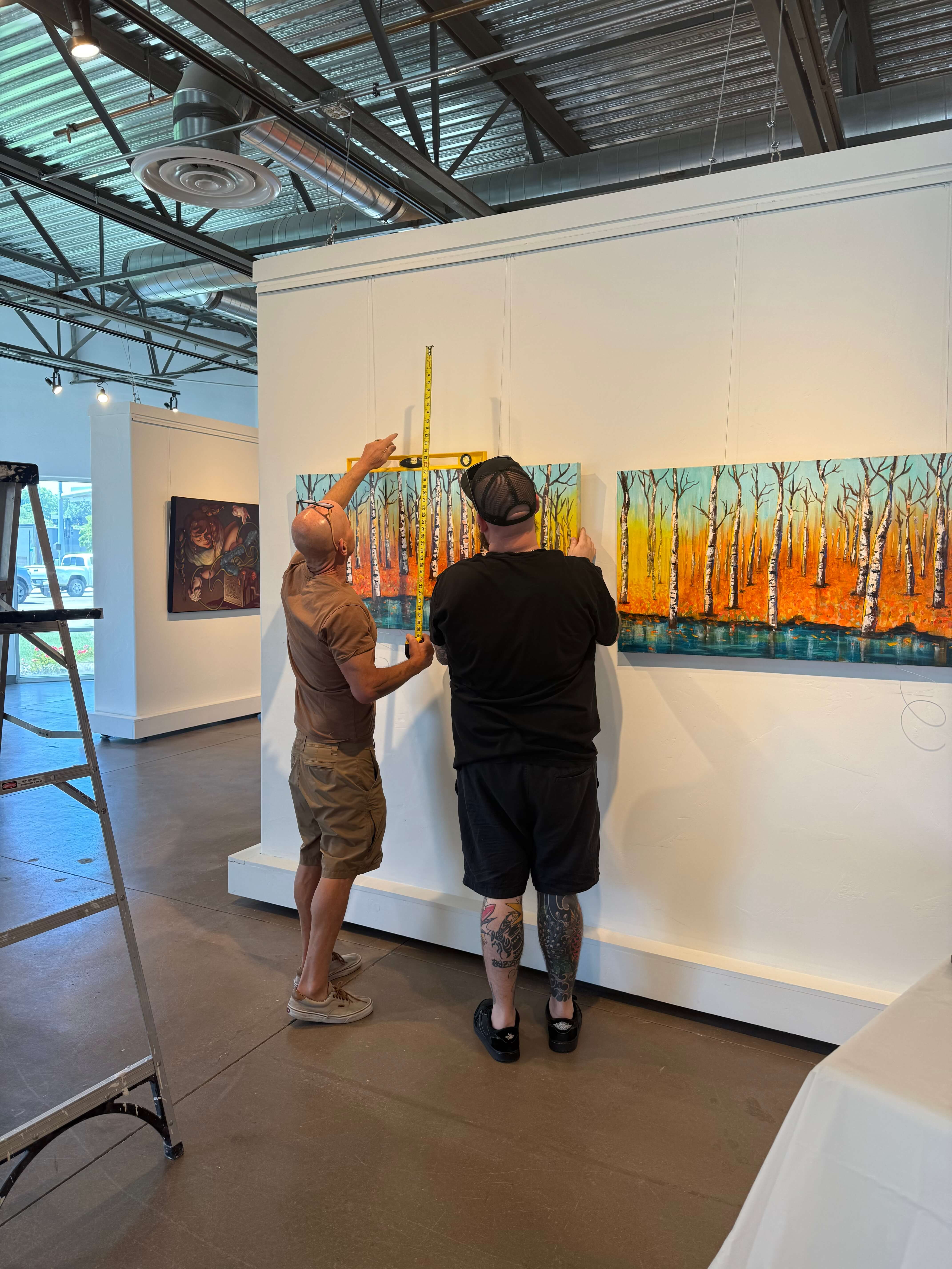 Artists Leo Bratenas and Jaymz Maurer measuring and hanging original artwork at Create Gallery & Frames in Garden City, Idaho. Artists Leo Bratenas and Jaymz Maurer measuring and hanging original artwork at Create Gallery & Frames in Garden City, Idaho.