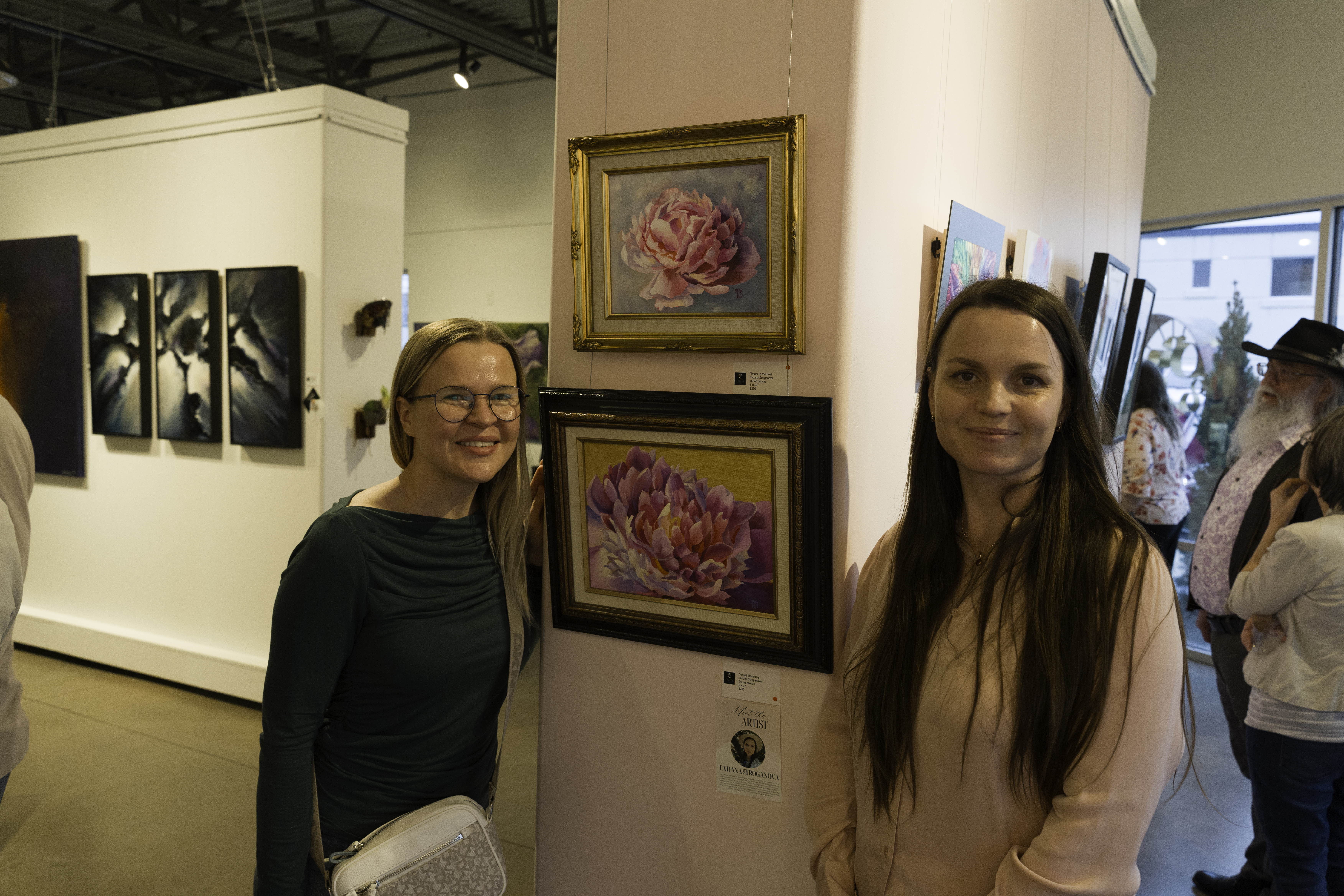 Buyer and Artist viewing floral artwork inside Create Gallery and Frames gallery in Garden City, Idaho