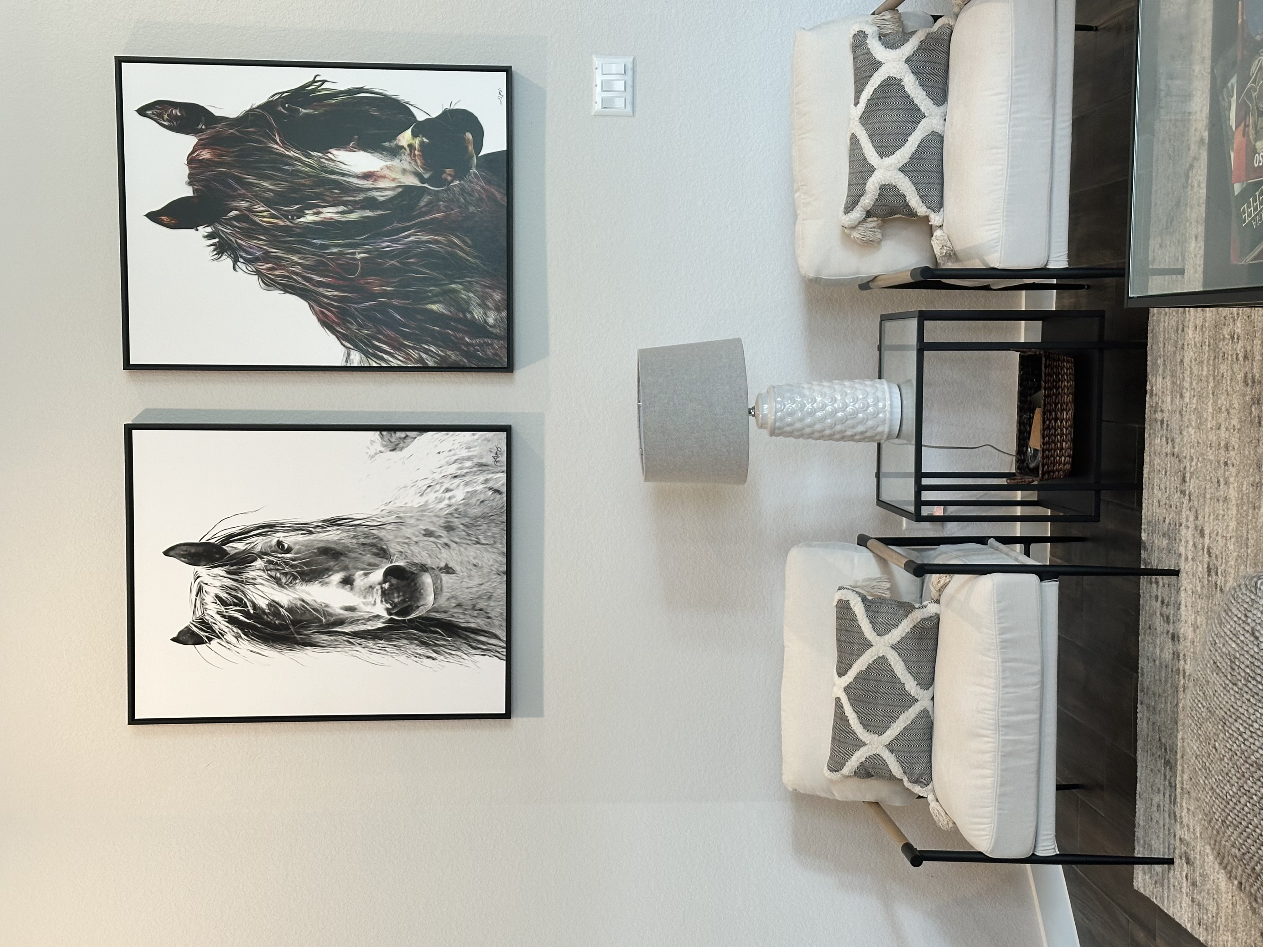 Horse artwork installed above a couch in a modern living room with neutral interior design