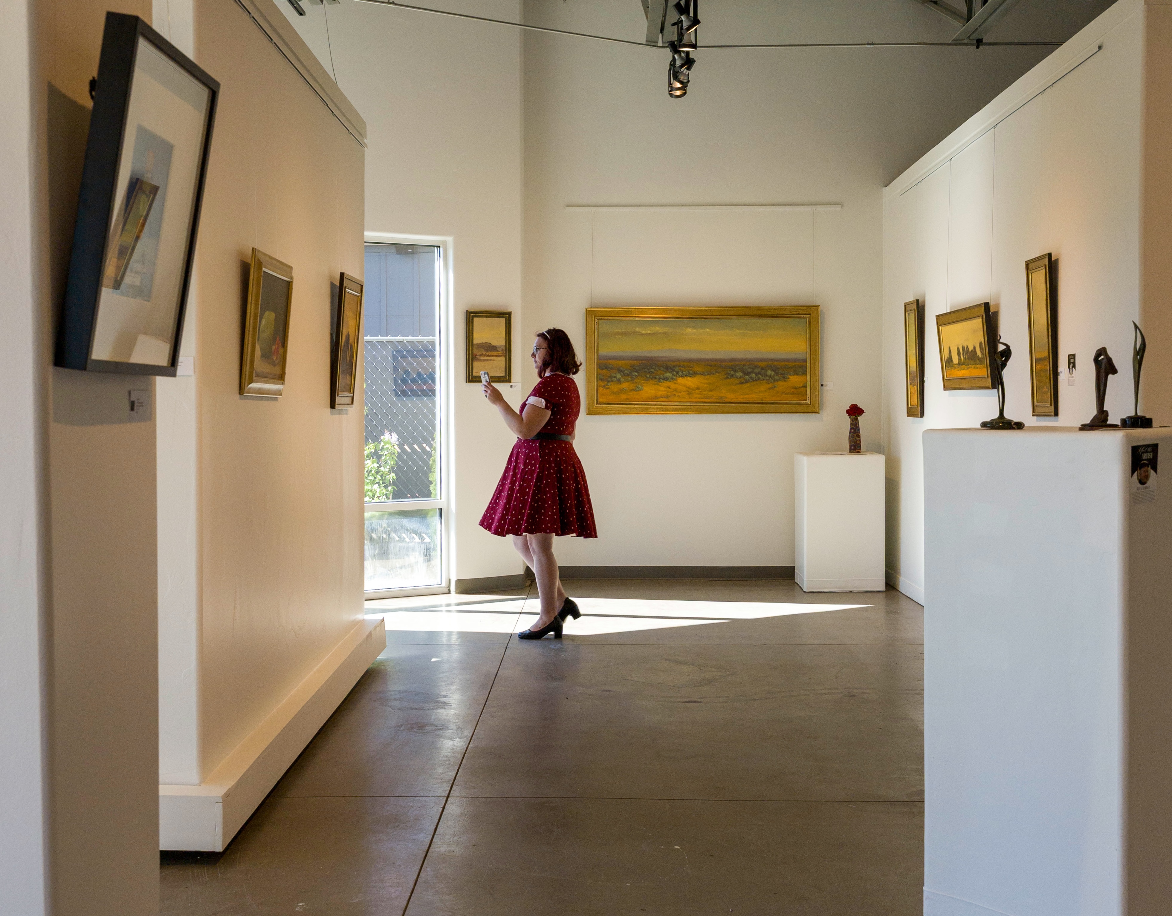 visitors exploring artwork inside Boise area art gallery Create Gallery and Frames in Garden City Idaho