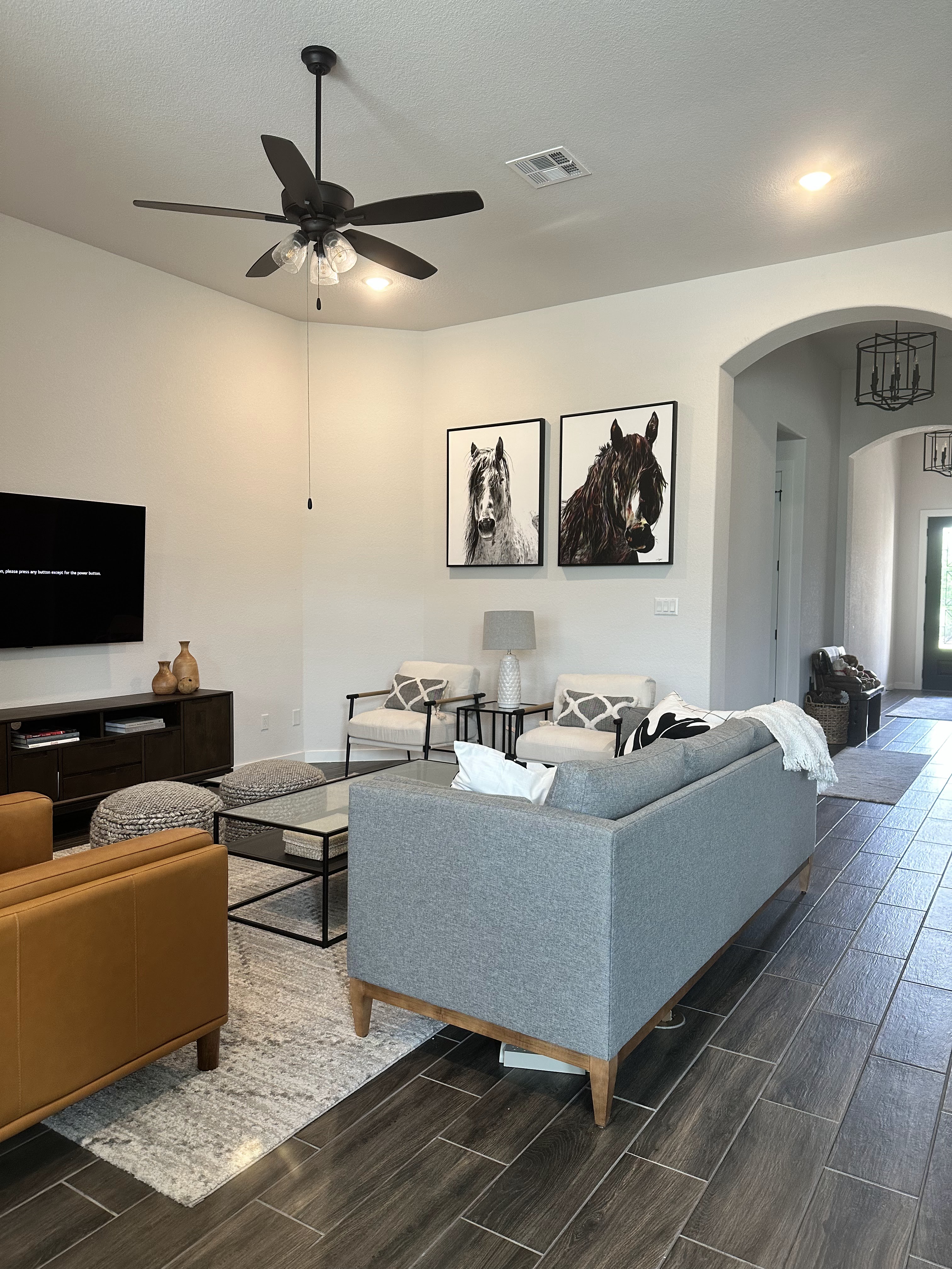 Properly scaled framed artwork hanging above furniture in a professionally designed interior Properly scaled framed artwork hanging above furniture in a professionally designed interior