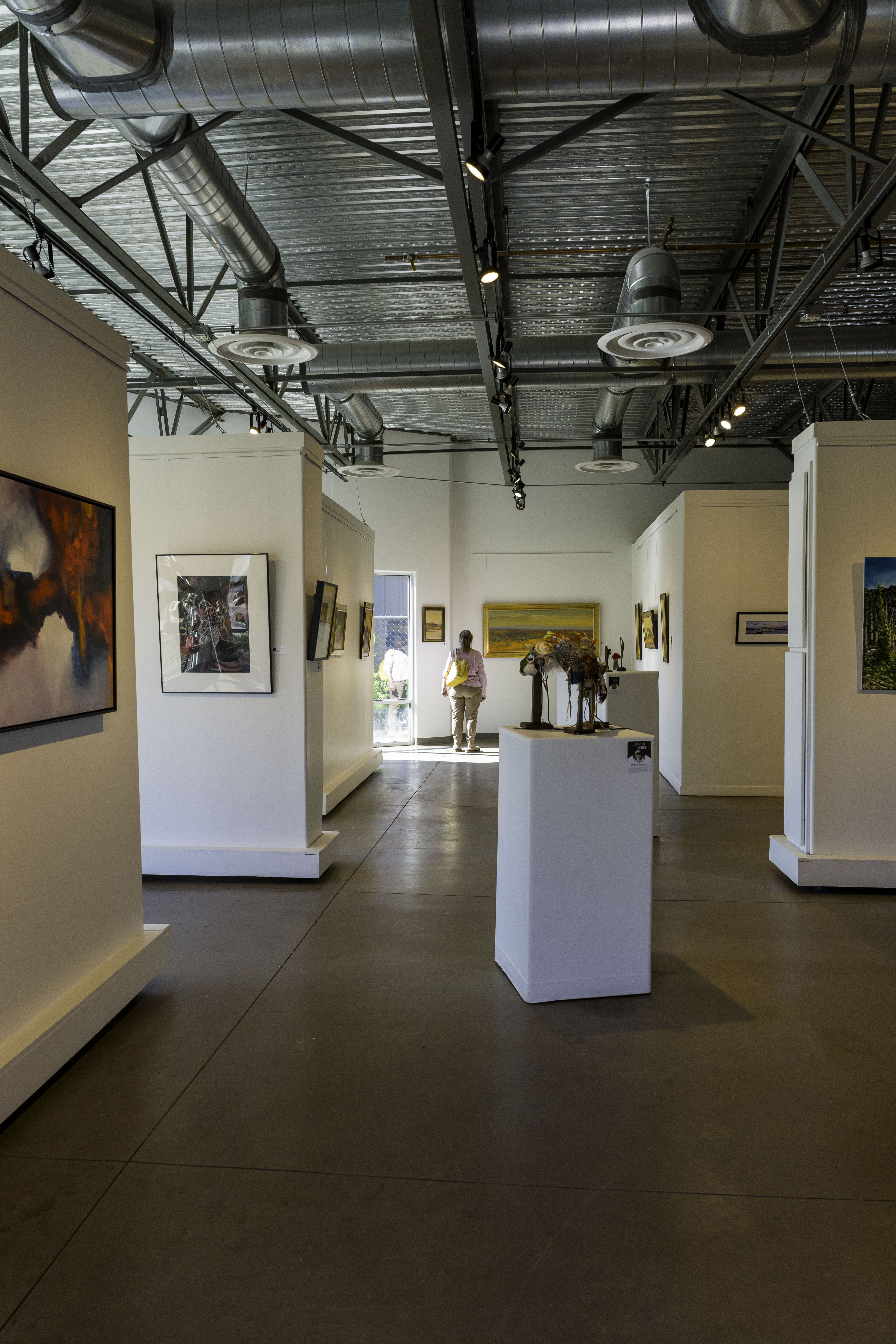 visitor exploring artwork at Create Gallery and Frames in Garden City Idaho near Boise