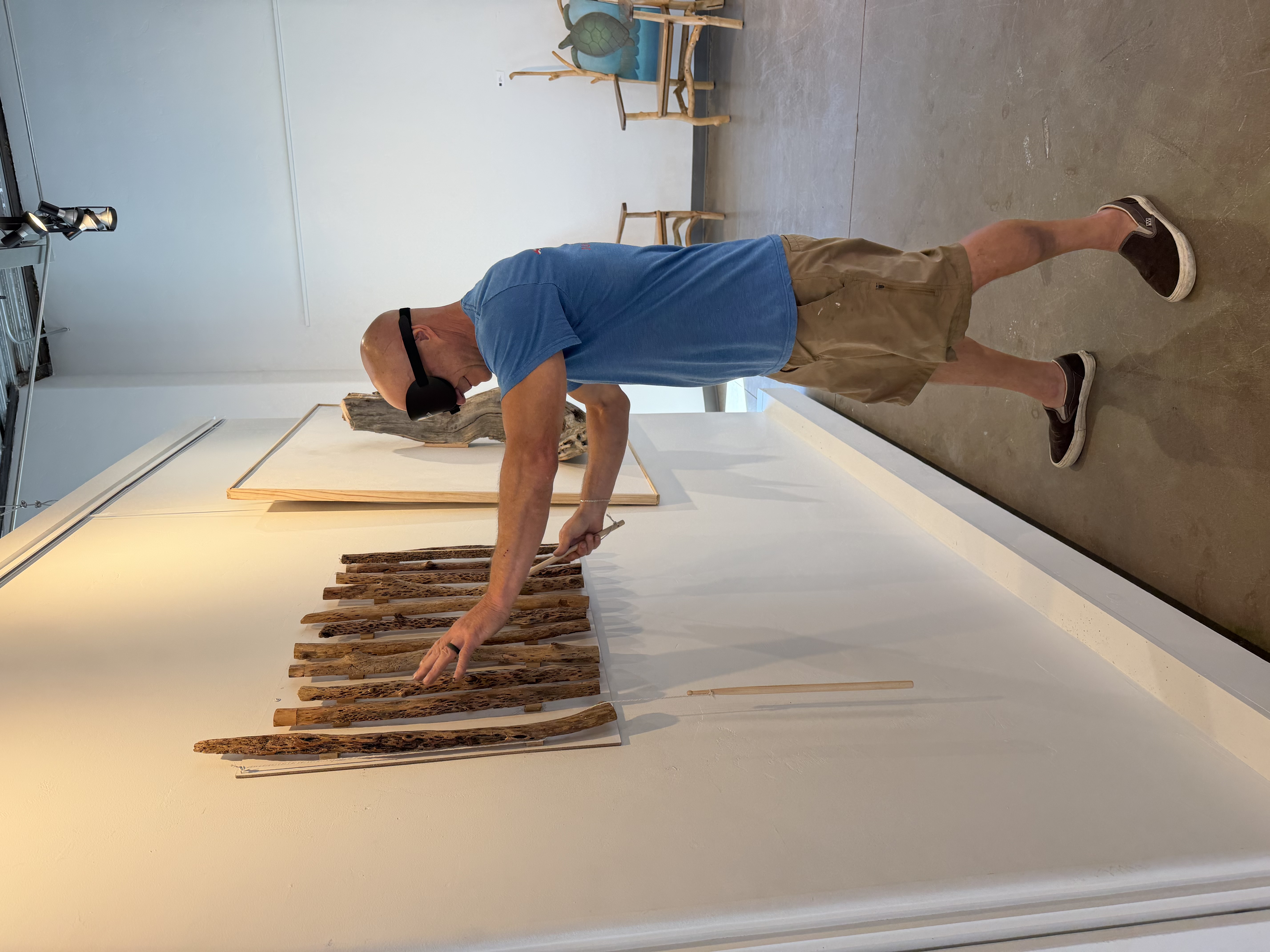 Leo Bratenas explores an interactive artwork while wearing a blindfold, using touch and sound to experience texture, form, and sensory elements beyond sight.