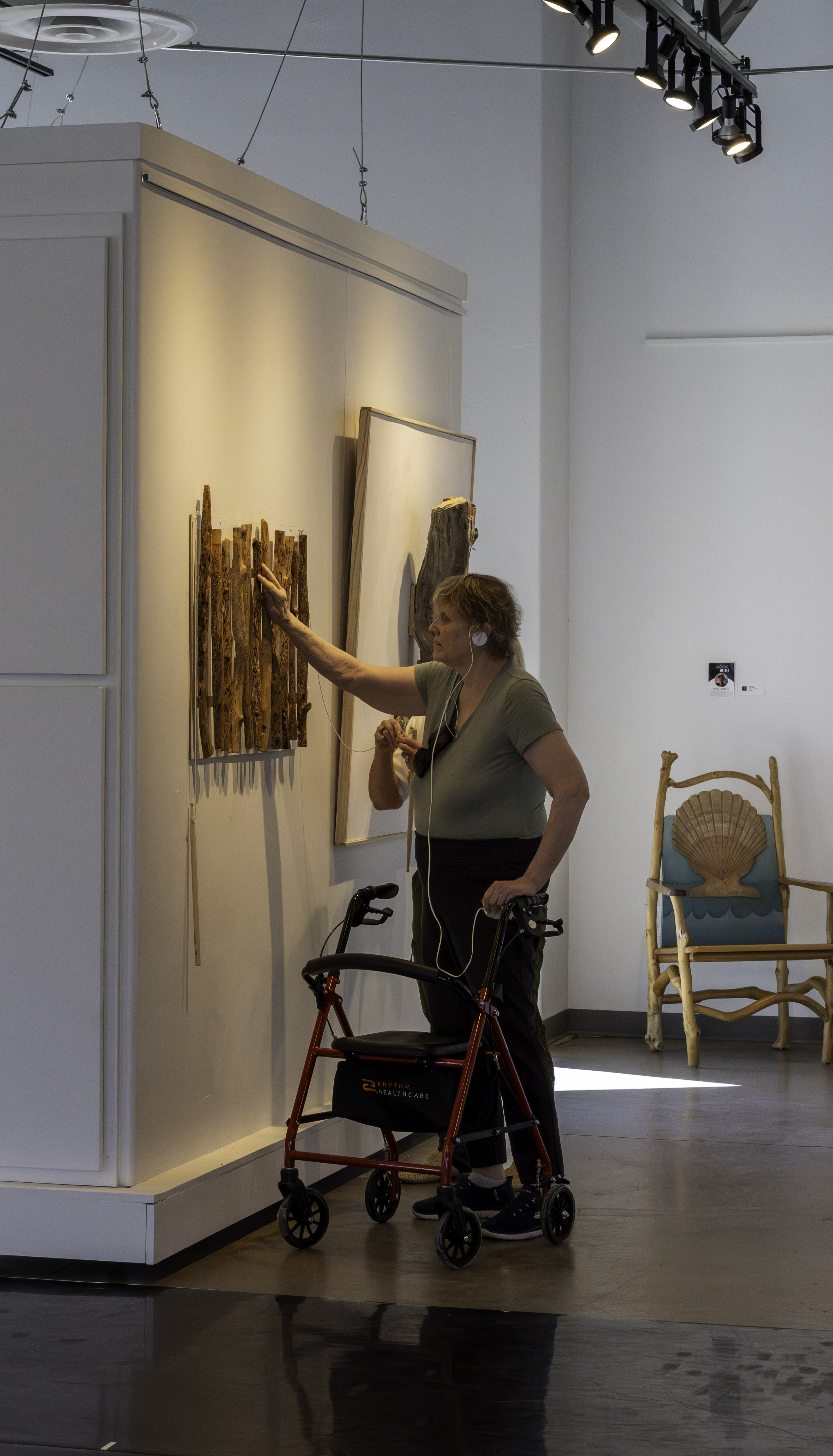 A blind visitor explores a tactile artwork by touch while listening to an audio description through headphones during the Touched by Art exhibition at Create Gallery & Frames. A blind visitor explores a tactile artwork by touch while listening to an audio description through headphones during the Touched by Art exhibition at Create Gallery & Frames.