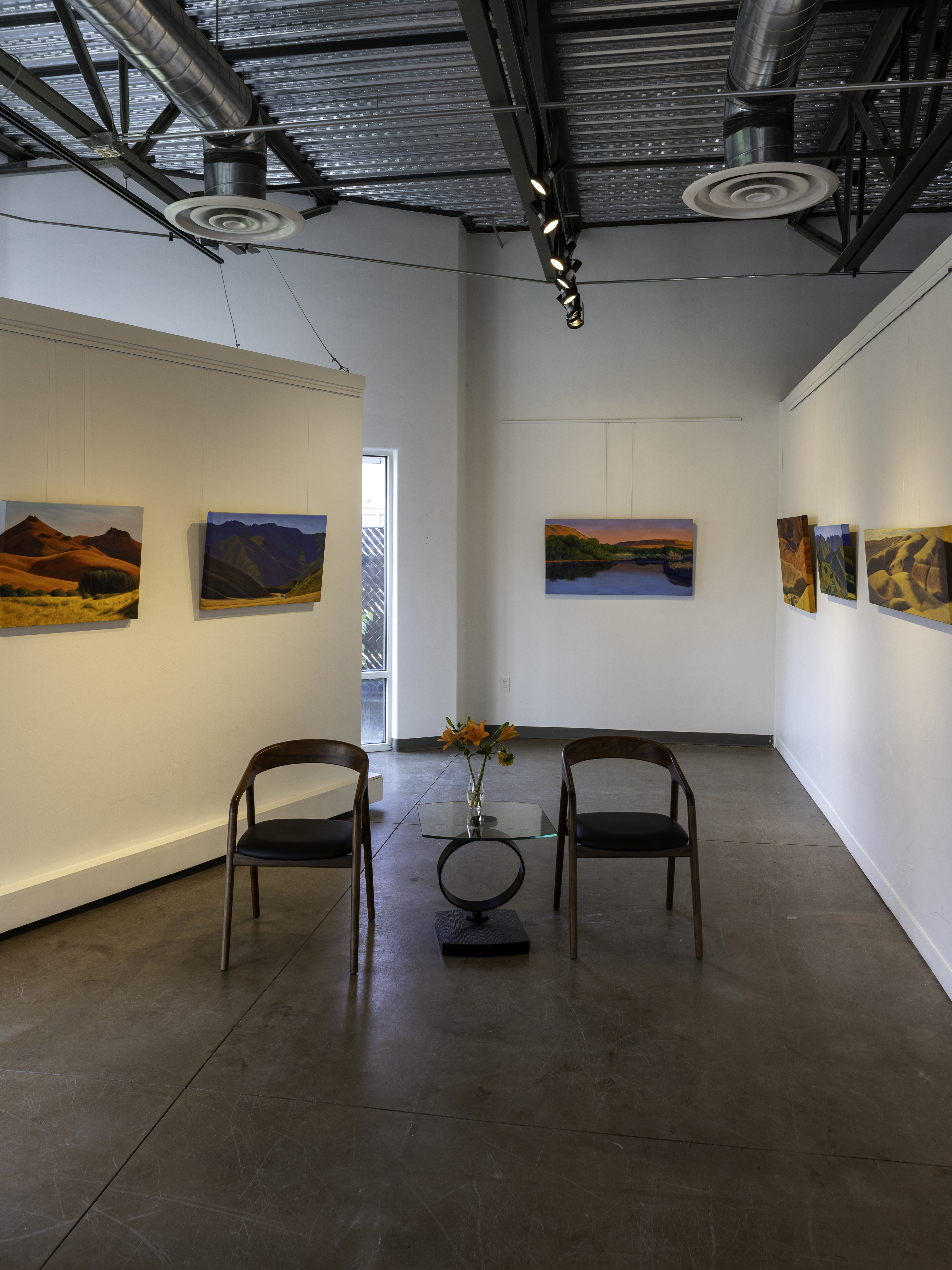 Gallery wall arrangement with evenly spaced framed artwork in a home interior Gallery wall arrangement with evenly spaced framed artwork in a home interior