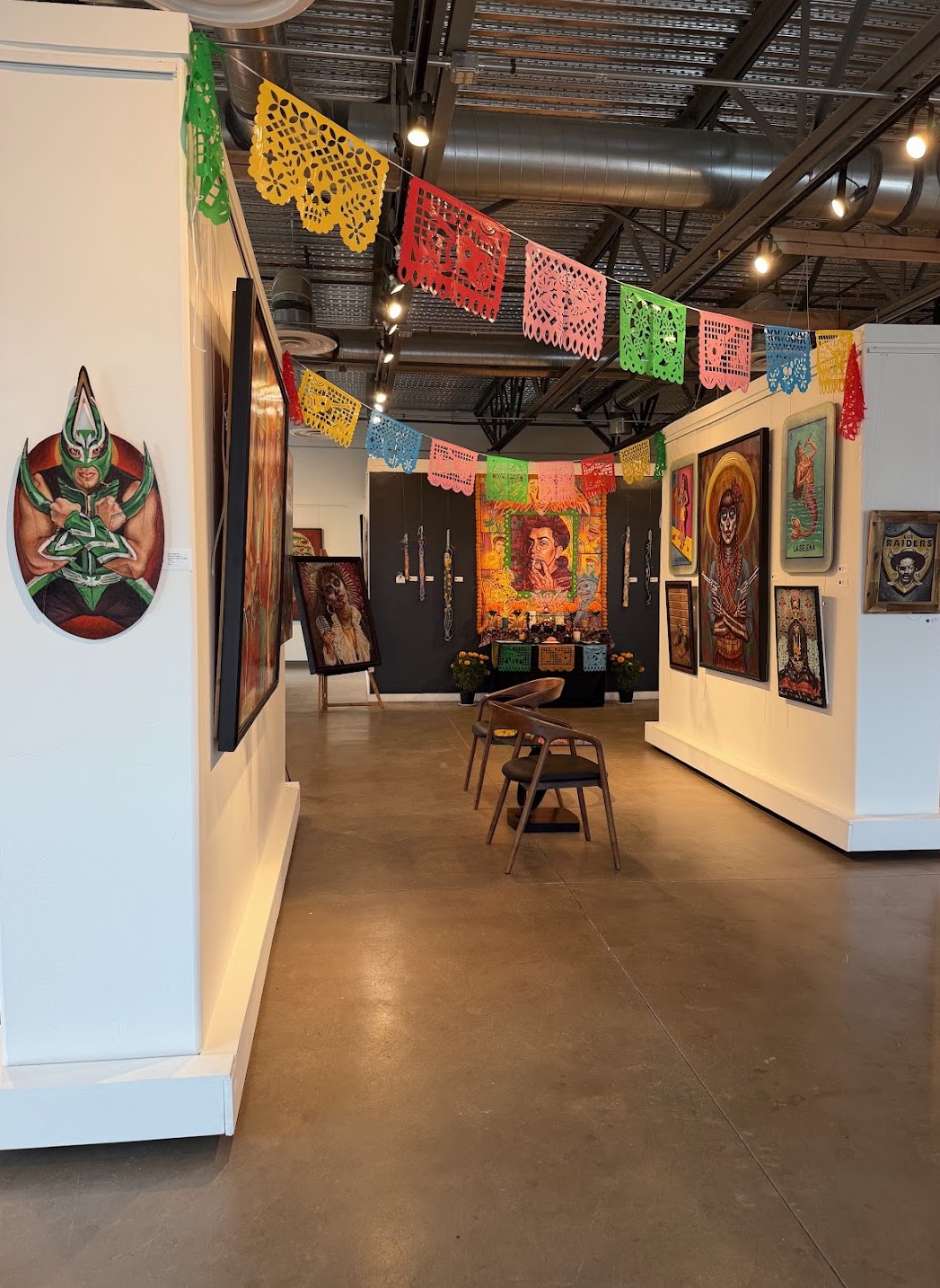 Interior of Create Gallery and Frames decorated with colorful papel picado and artwork for its October Día de los Muertos exhibition. Interior of Create Gallery and Frames decorated with colorful papel picado and artwork for its October Día de los Muertos exhibition.