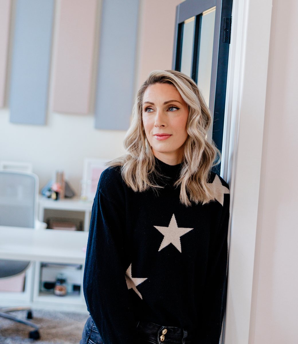 Carrie Green in her office, wearing a dark jumper with stars