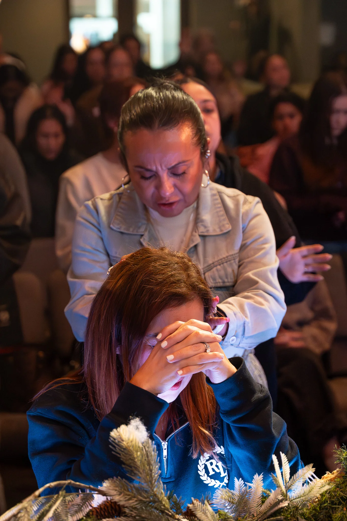 Women praying together at Radiant Girls