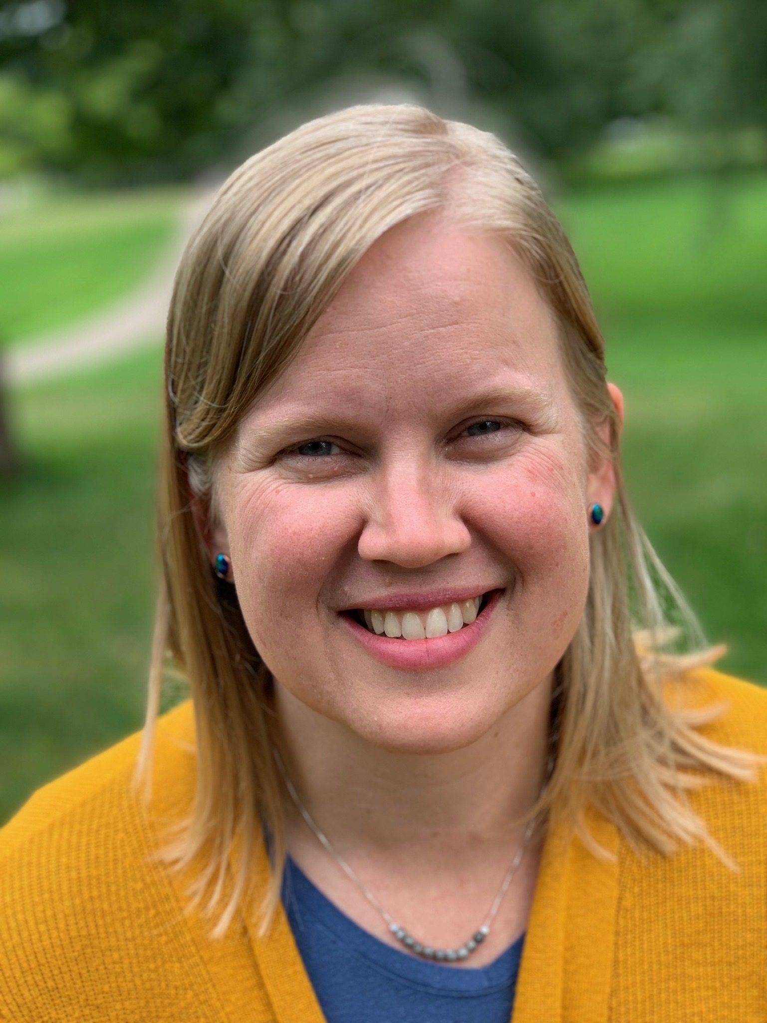 Maren Goerss smiling, wearing a mustard cardigan