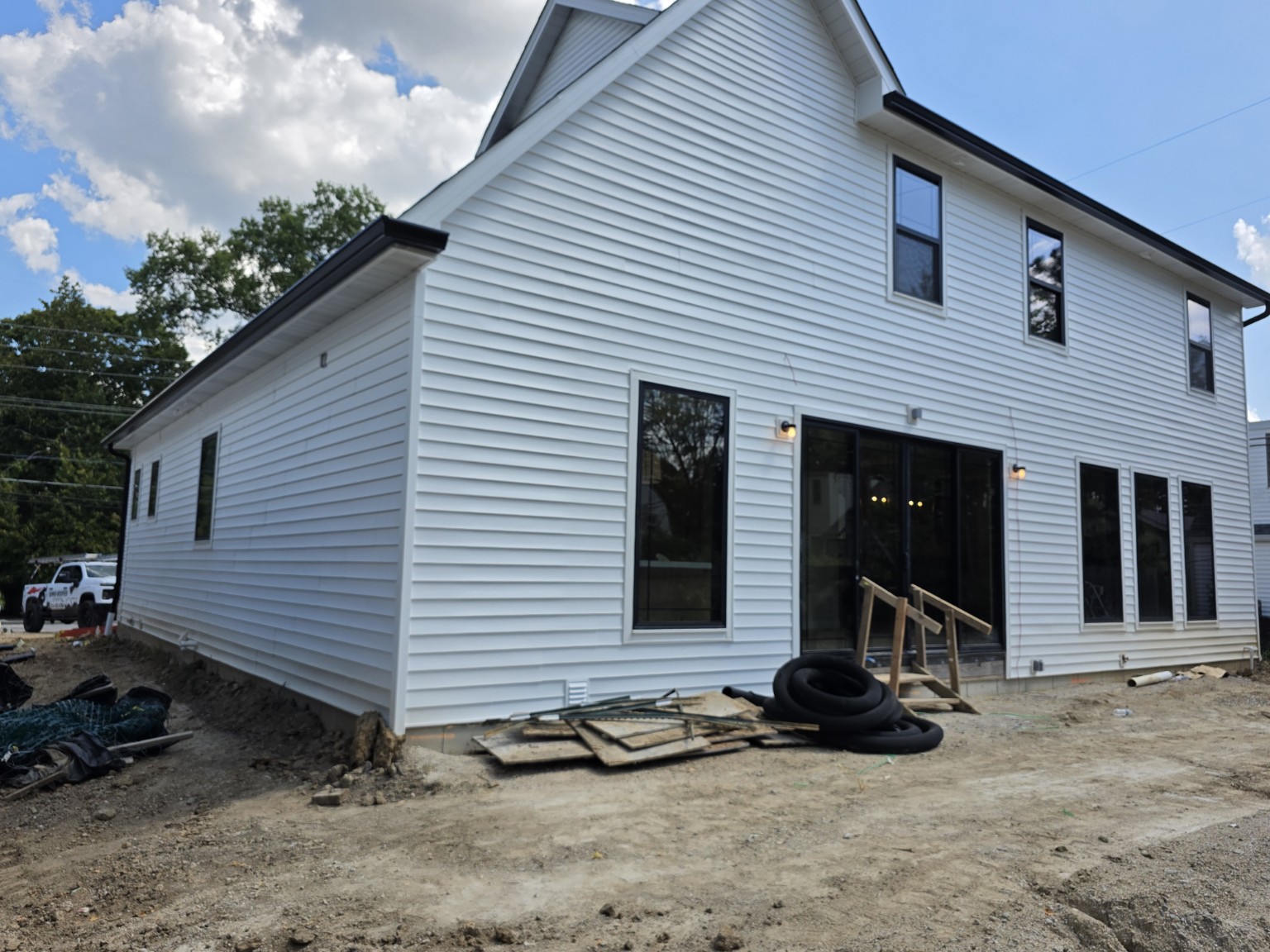 Black gutters installed along the rear of a white Kirkwood home
