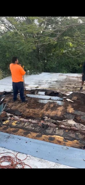 Flat roof tear-off — failed membrane and rotted deck exposed — AGK Construction South Florida