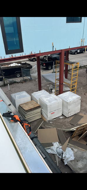Tapered polyisocyanurate insulation boards staged for installation — AGK Construction South Florida