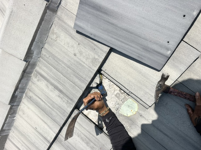 AGK Construction owner inspecting metal roof — South Florida licensed roofing contractor