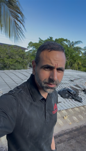 Tile roof repair — tiles removed, underlayment sealed with black cement before reinstallation — AGK Construction South Florida