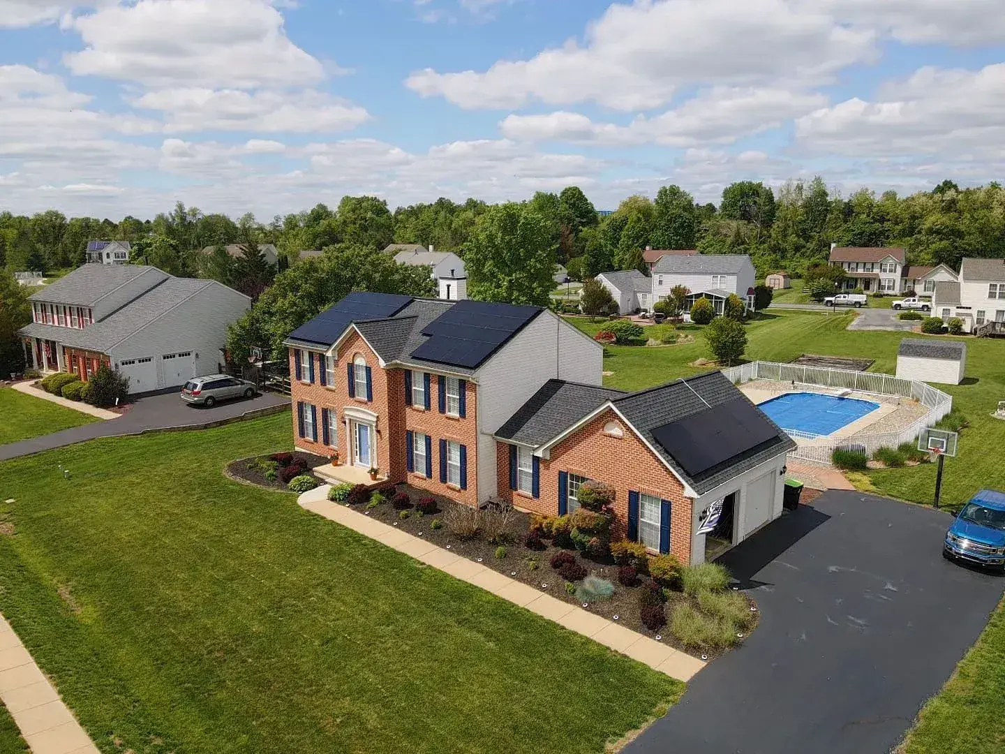 Aerial view of solar panels on a brick home