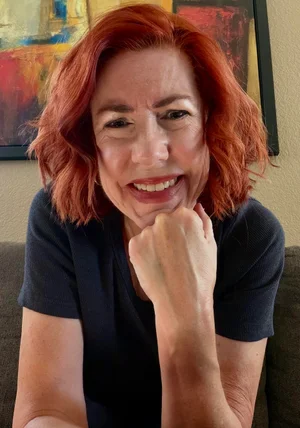 Monica Goodpaster laughing, chin resting on her hand