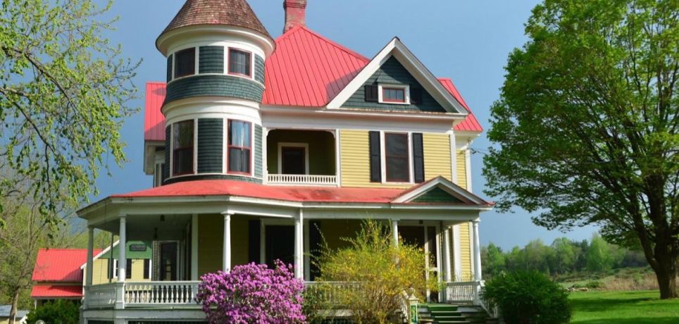 The turreted Queen Anne main house