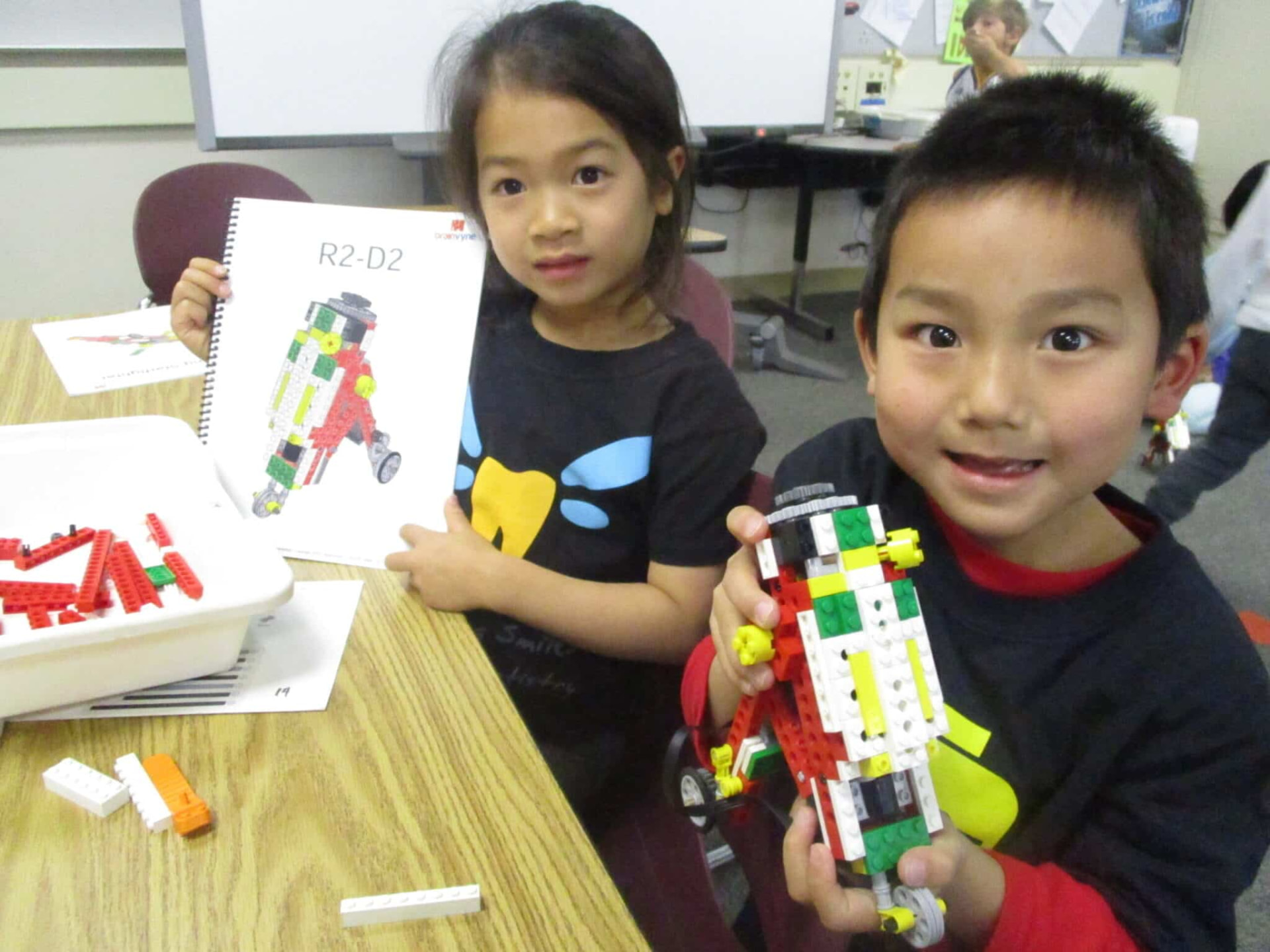 Two campers showing their LEGO robot build at Thanksgiving Camp