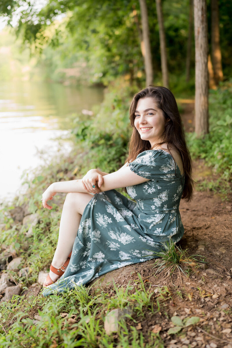 A bride and groom smile while walking arm in arm through a tunnel of their wedding party.