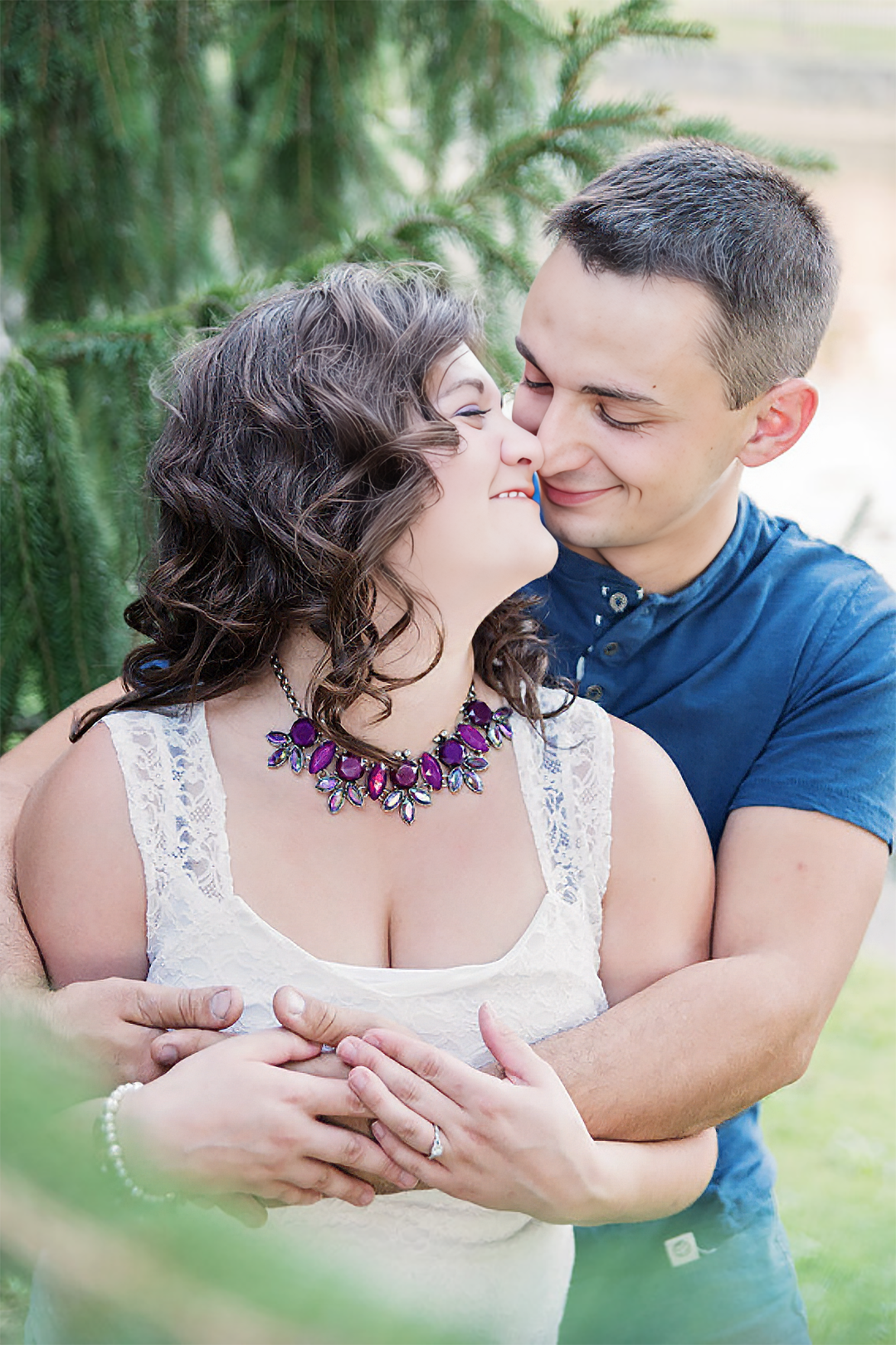 A bride and groom smile while walking arm in arm through a tunnel of their wedding party.