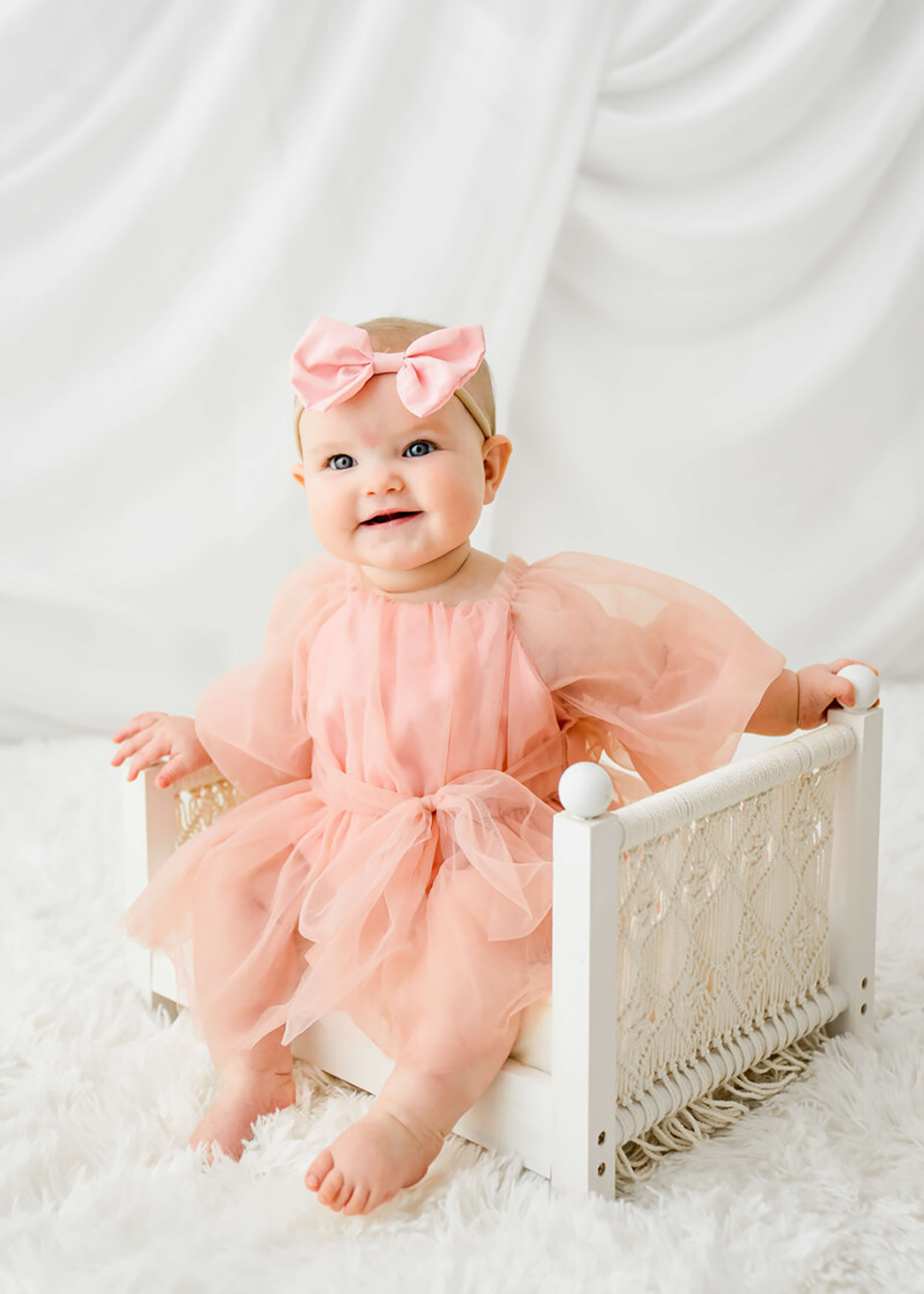 A newborn sleeps while supported by  mom dad.