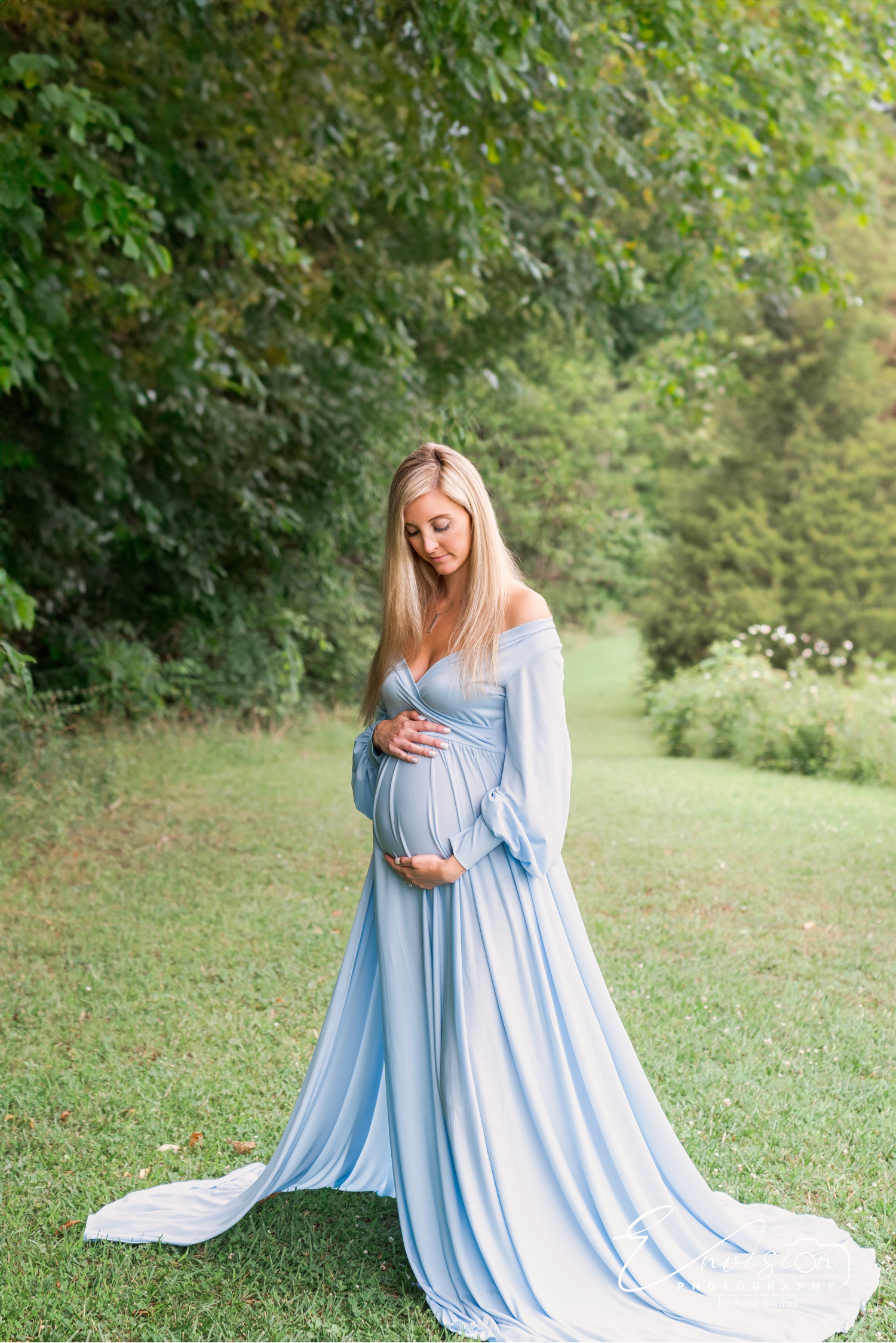 Children joining their mother for outdoor maternity portraits