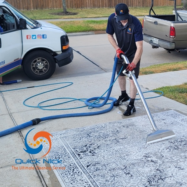 Cleaning rug on driveway Cleaning rug on driveway