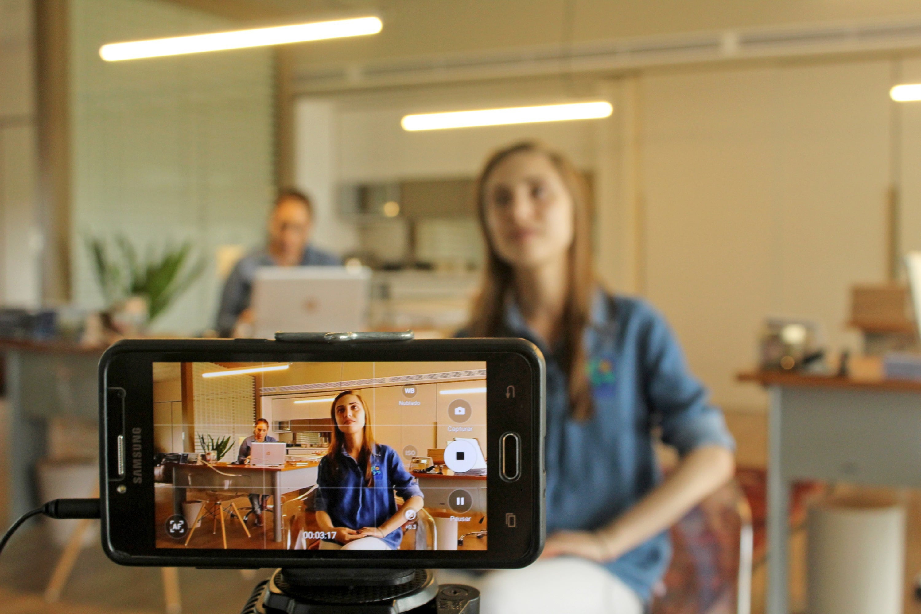 Woman filming herself on iphone 