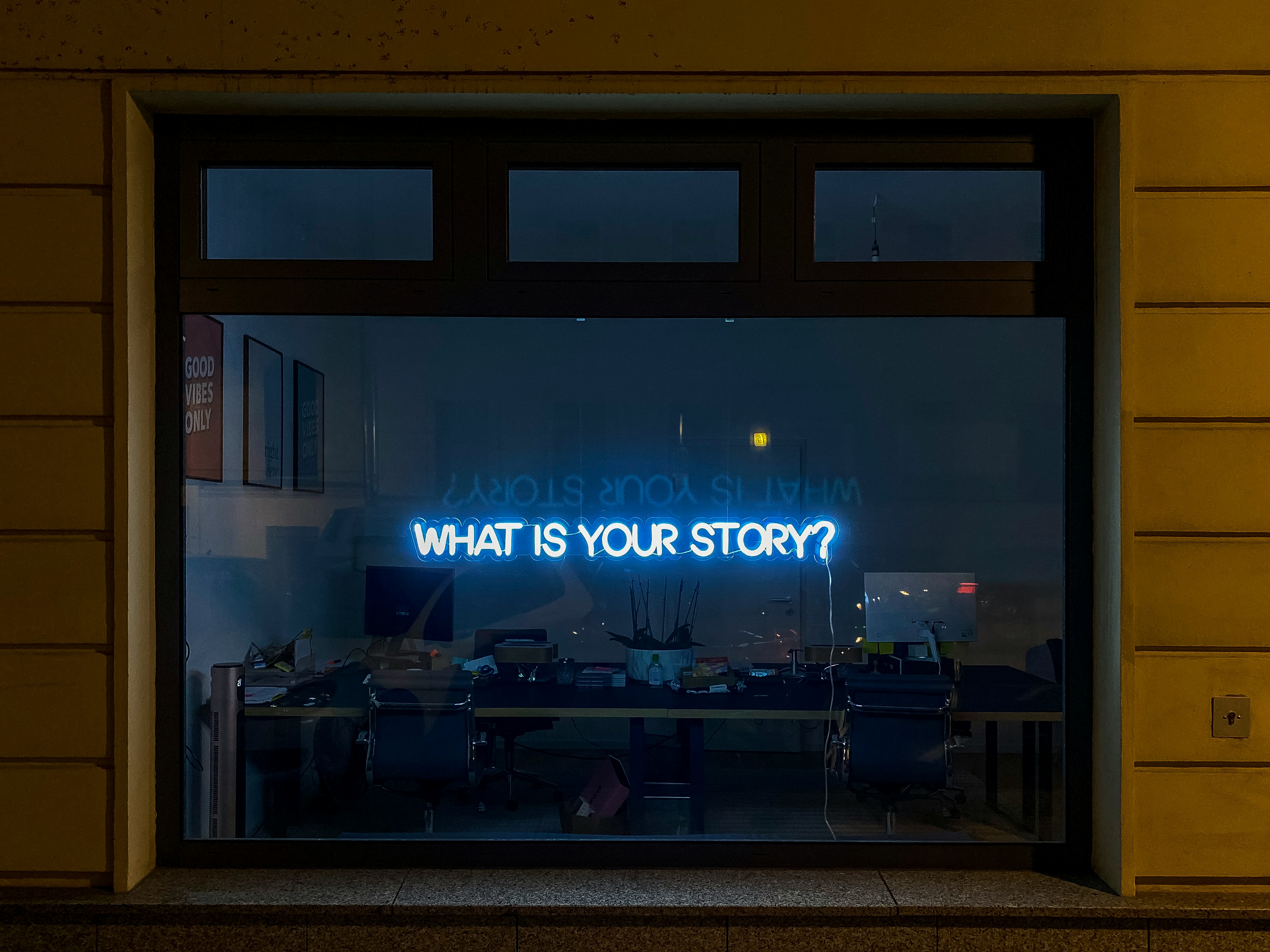 Window with 'what's your story?' sign in it 