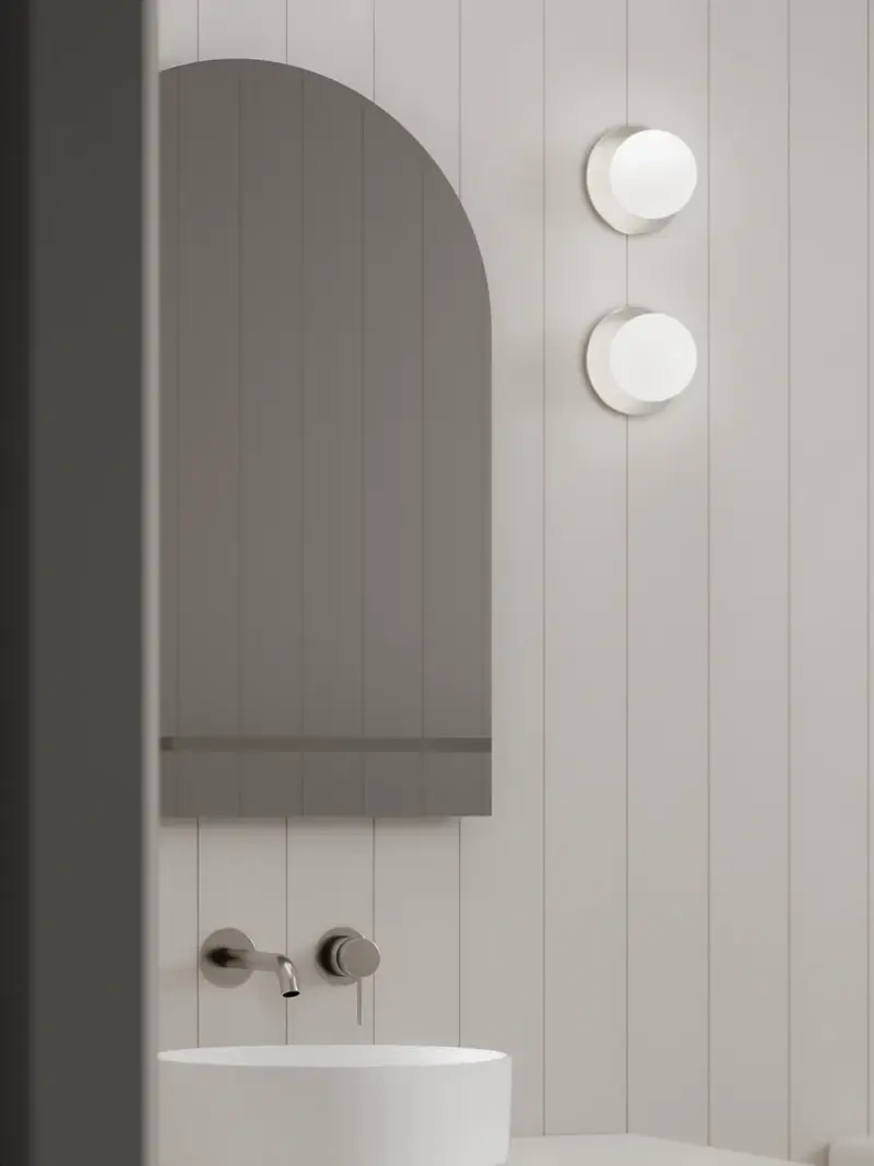 Arched mirror, brushed nickel tapware and vertical panelling